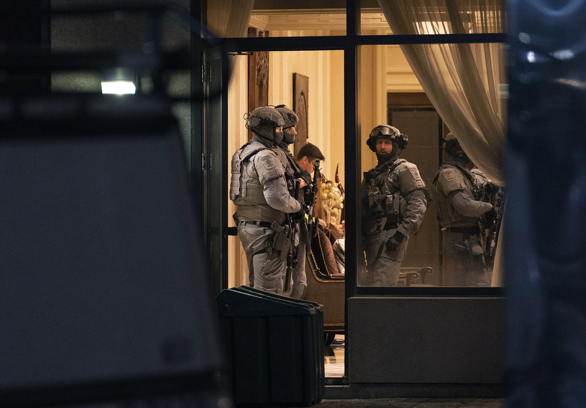 York Regional Police tactical officers stand in the lobby of a condominium in Vaughan, Ontario, Canada on Sunday. Five people and a suspect are dead after a shooting in the building, police said.