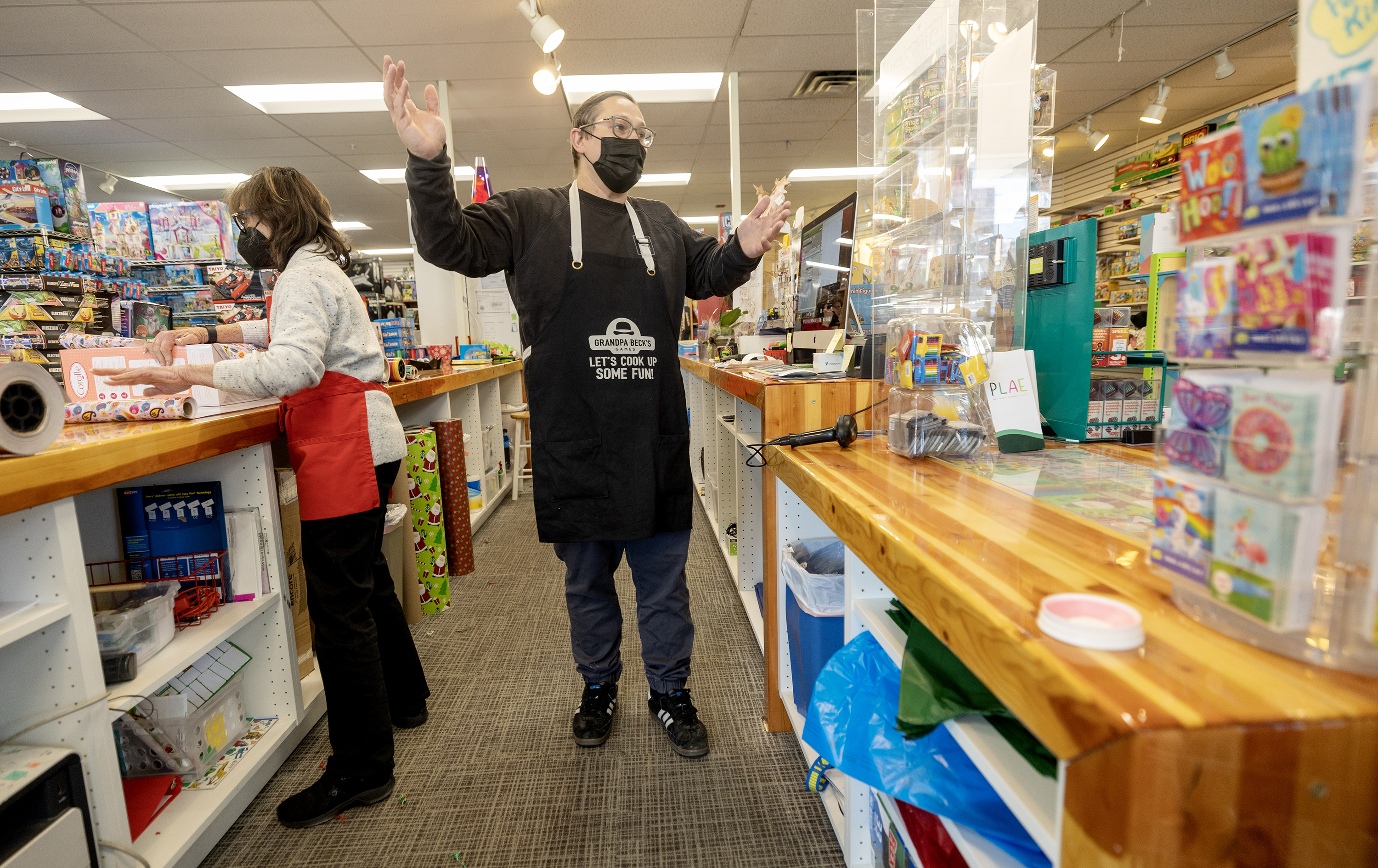 Casey Sartain talks to a customer at his parents’ store, the Tutoring Toy, in Salt Lake on Monday.