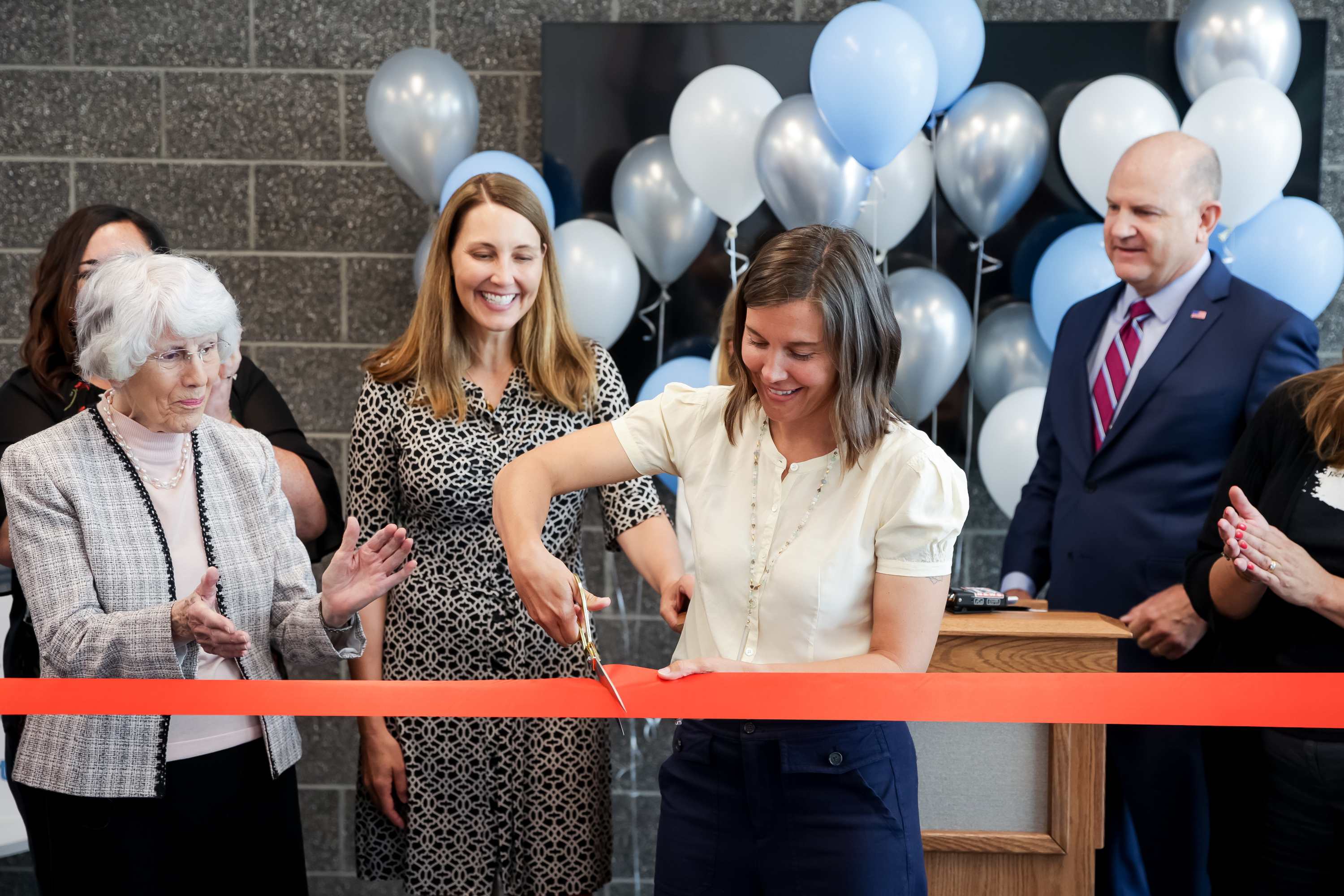 Salt Lake City Mayor Erin Mendenhall, center, cuts a ribbon during the opening of Magnolia, a new permanent supportive housing building operated by the Road Home, in Salt Lake City on June 24, 2021. On Monday and Tuesday, the Road Home is holding its holiday fundraiser that funds access to emergency shelters and more.