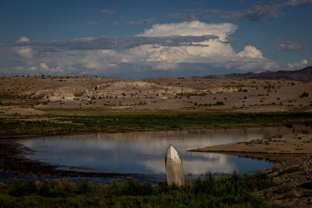 A previously sunken boat now sticks vertically out of mud on the shores of Lake Mead as the reservoir’s water levels have declined near Boulder City, Nev., on Oct. 9.