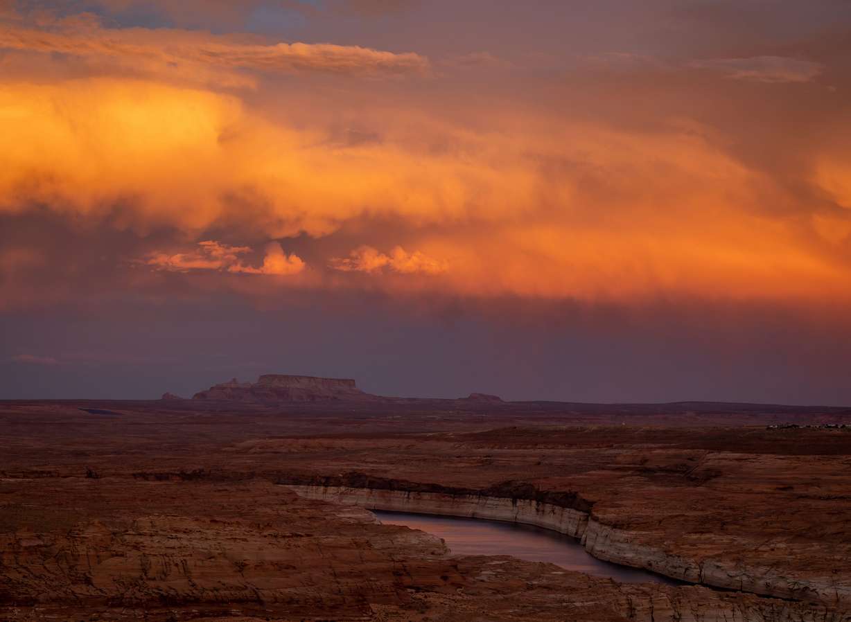 The sun sets on a stretch of Lake Powell near the Glen Canyon Dam in Page, Ariz., on July 19.