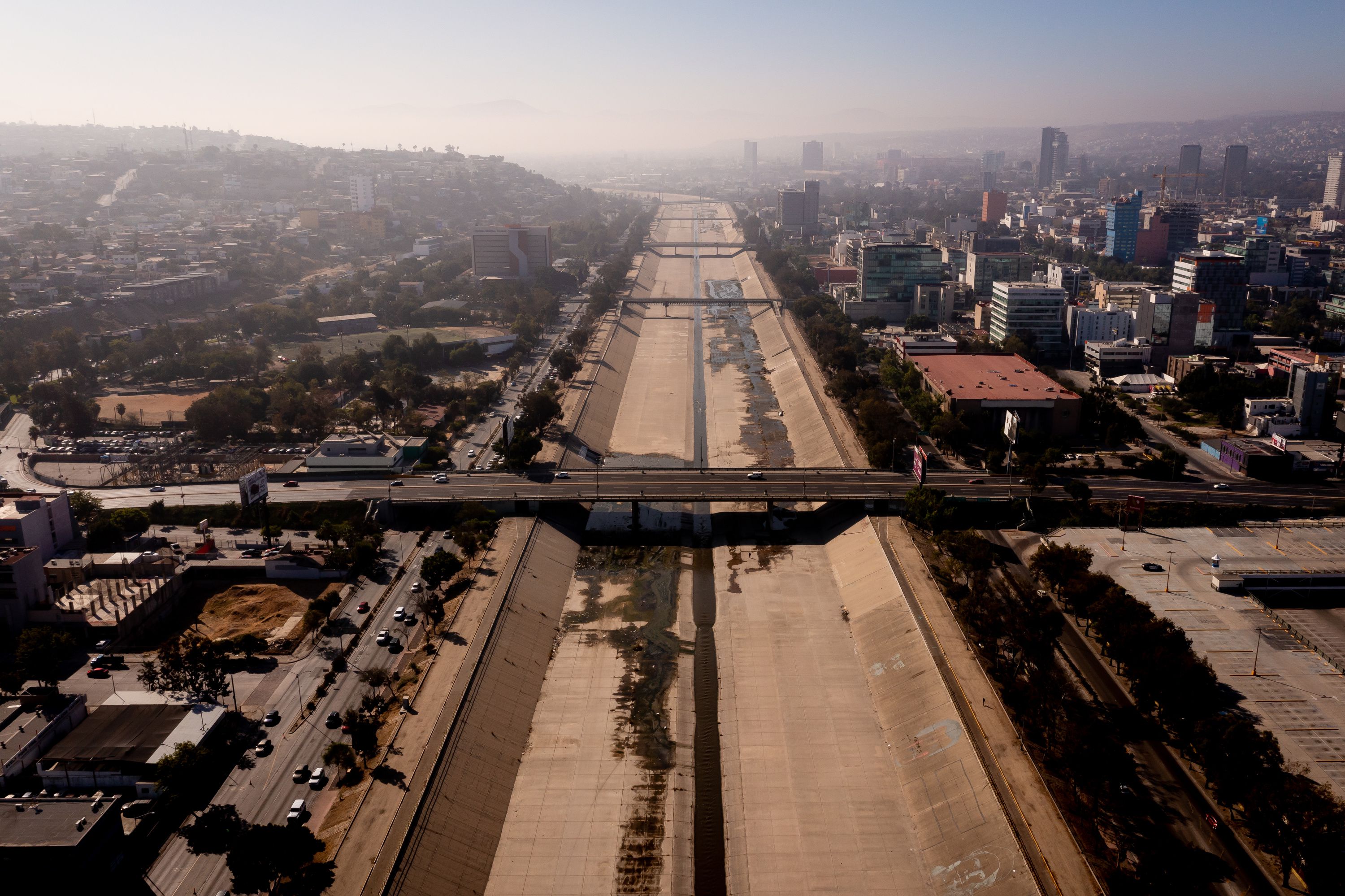 A small flow of water moves through the Tijuana River, which has been converted into a paved channel, in Tijuana, Baja California, Mexico, on June 26.
