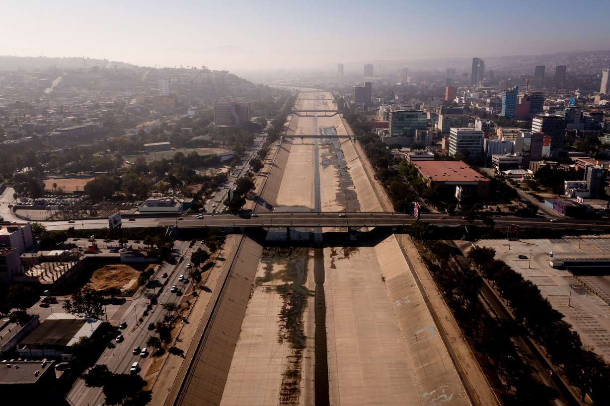 A small flow of water moves through the Tijuana River, which has been converted into a paved channel, in Tijuana, Baja California, Mexico, on June 26.
