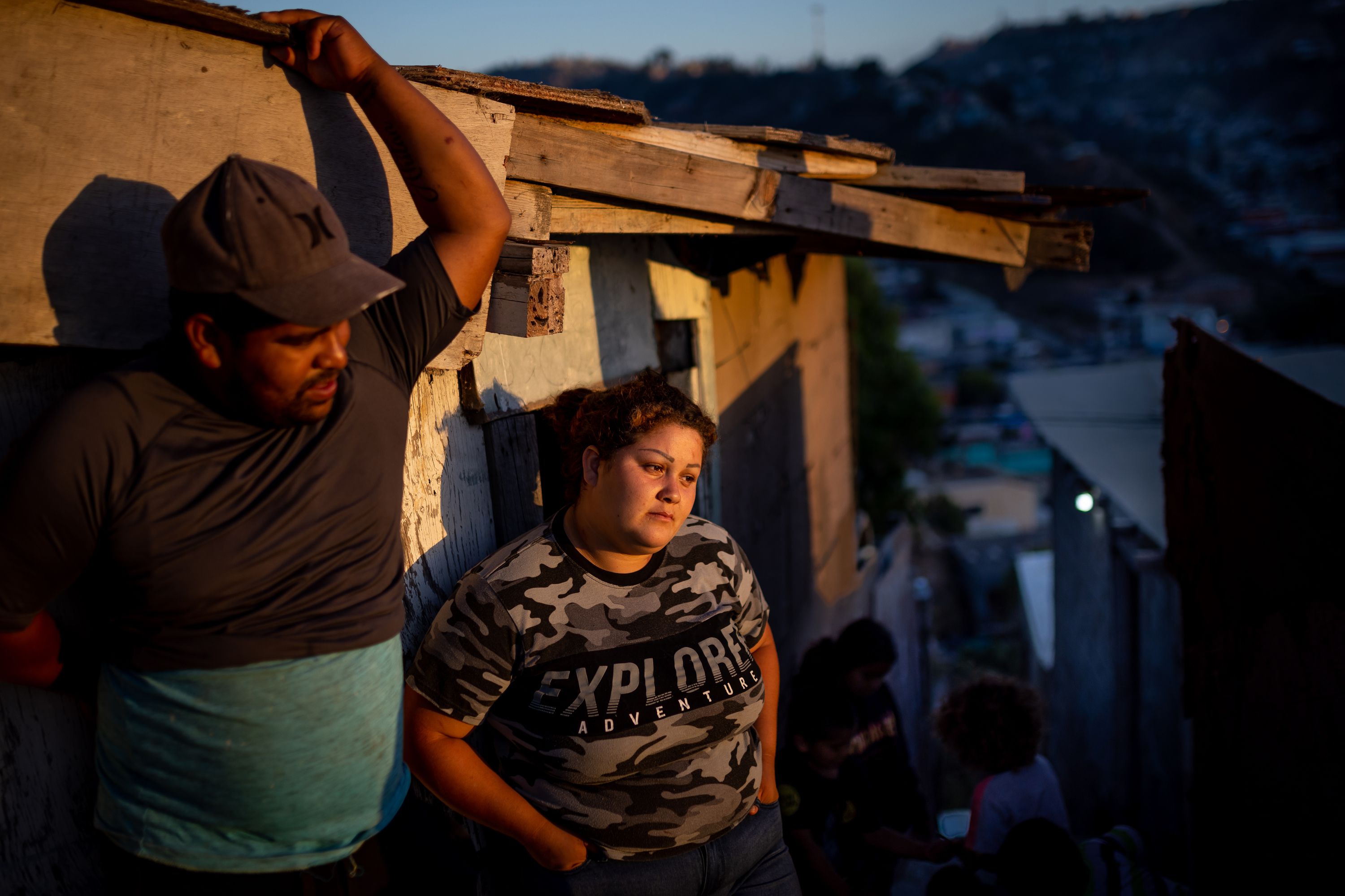 Gustavo Rosales, 23, and his wife, Adriana Mendoza, 22, stand outside their home in the Los Laureles neighborhood of Tijuana, Baja California, Mexico, on June 25.