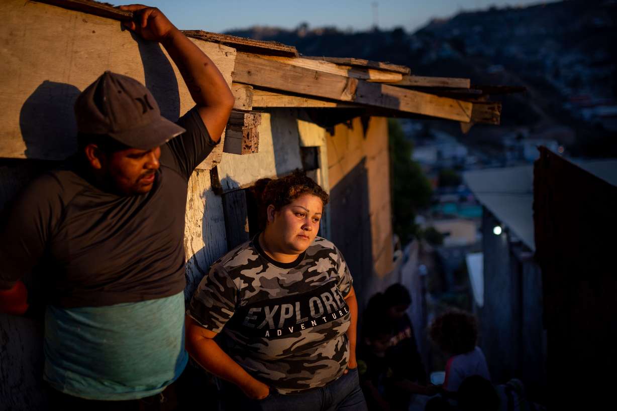 Gustavo Rosales, 23, and his wife, Adriana Mendoza, 22, stand outside their home in the Los Laureles neighborhood of Tijuana, Baja California, Mexico, on June 25.