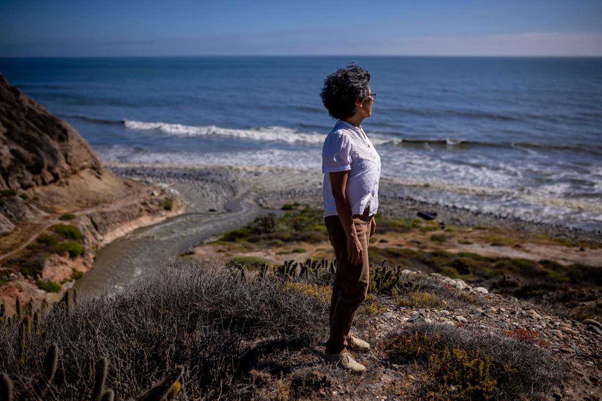 Margarita Diaz poses for a photo next to an outflow of untreated sewage flowing into the Pacific Ocean in Tijuana, Baja California, Mexico, on June 25.
