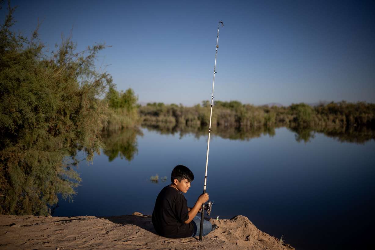 Axel Yael Aguirre, 9, fishes on the banks of the Colorado River in Mexicali, Baja California, Mexico, on June 24.
