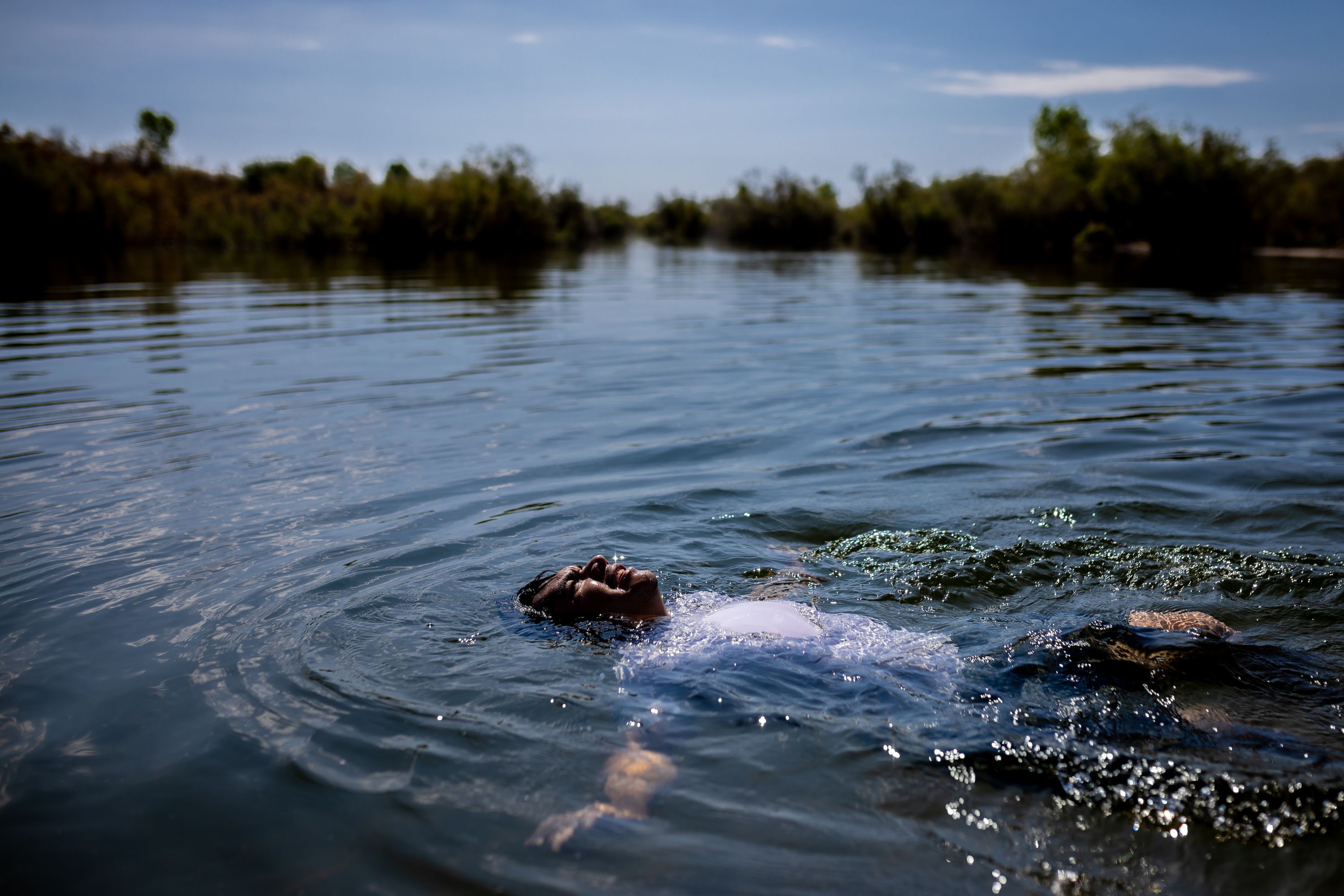 Edgar Carrera, the Colorado River Delta coordinator for The Nature Conservancy, swims after taking part in a community cleanup event at a popular swimming hole along the Colorado River in Mexicali, Baja California, Mexico, on June 24.