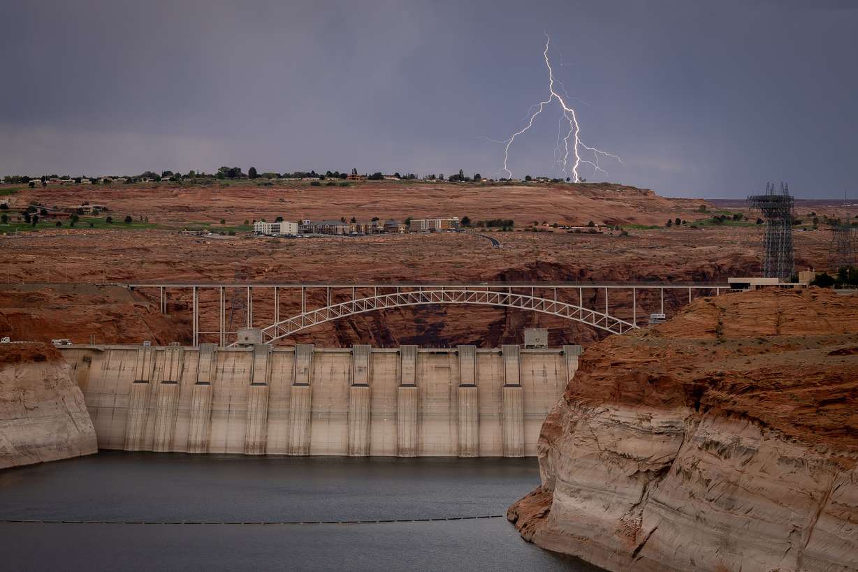 Lightning strikes behind Page, Ariz., and the Glen Canyon Dam on July 19.