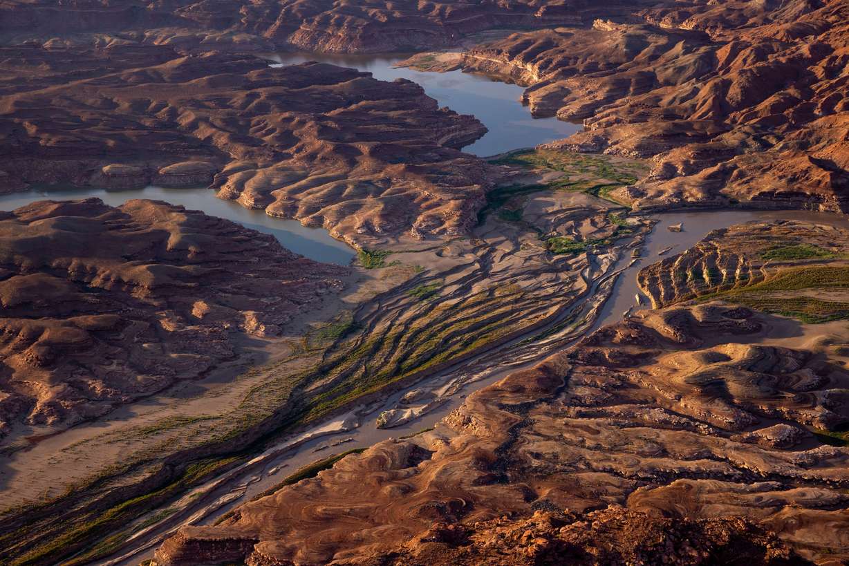 The Colorado River cuts a channel through sediment where Lake Powell has receded in southern Utah on July 22.