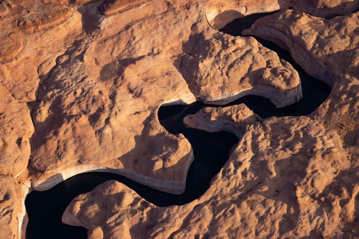 The waters of Lake Powell flood a side canyon in southern Utah on July 22. The band of pale rock, the so-called bathtub ring, shows how far the reservoir has receded from its high water mark.