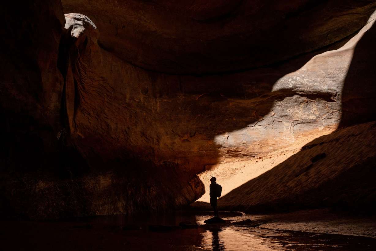 Eric Balken, executive director of Glen Canyon Institute, takes in Cathedral in the Desert, an amphitheater inside Clear Creek Canyon off the Escalante River portion of Lake Powell, while on a media tour on Oct. 6. The formation was, for many years, deep under the waters of Lake Powell but has reemerged as the reservoir’s water levels have declined.