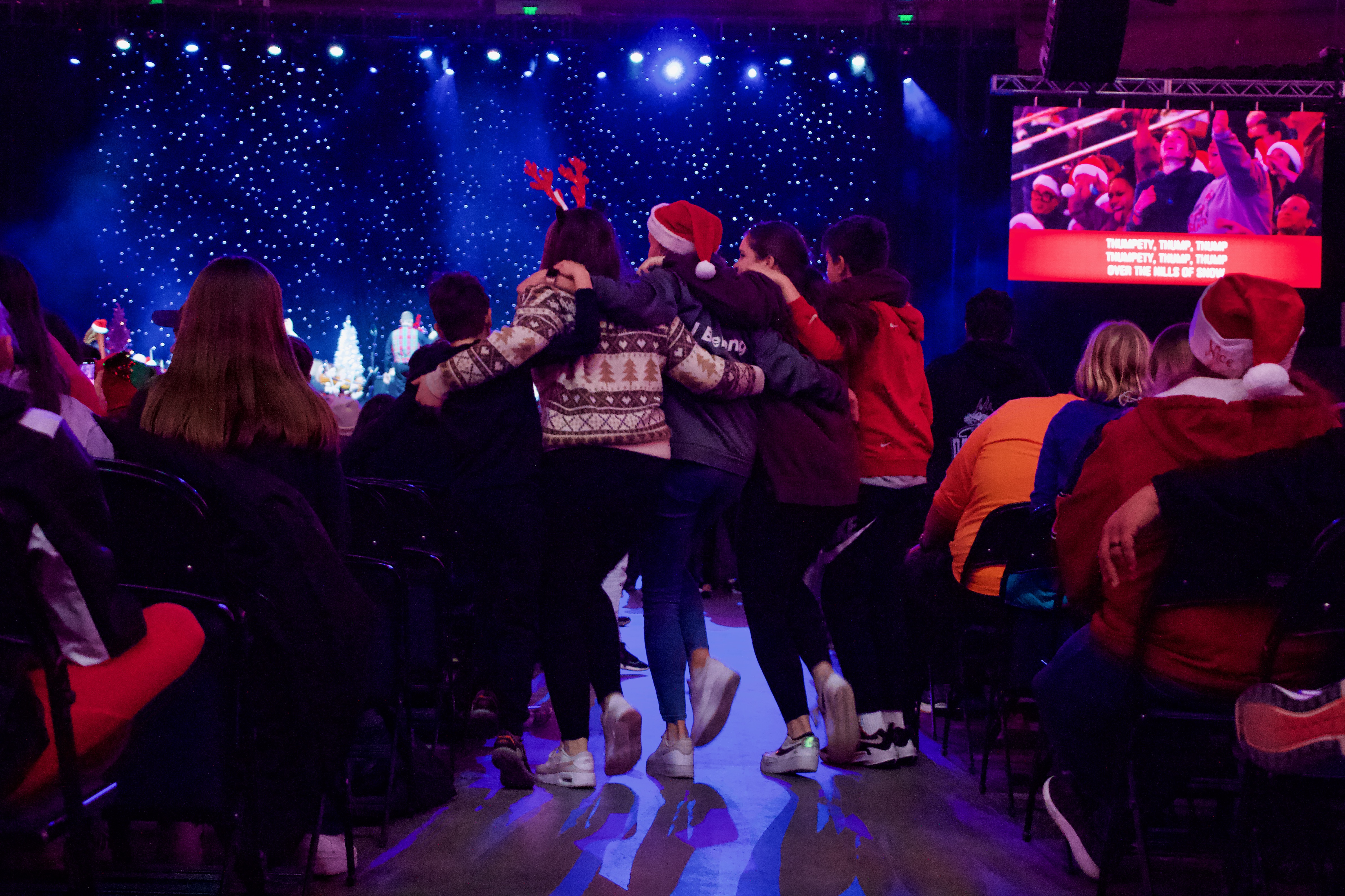 A group of kids dances together at the 38th annual Larry H. Miller Christmas Carol Sing-Along at the Vivint Arena on Wednesday.