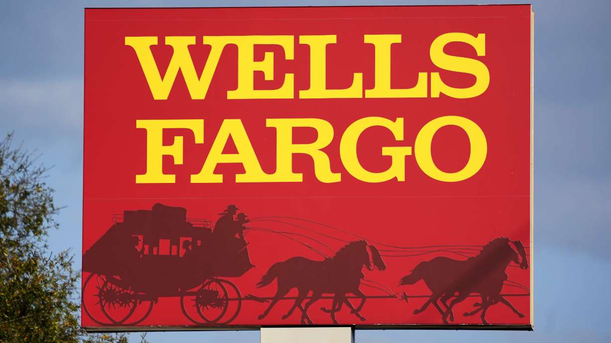 A Wells Fargo sign stands in front of a branch in Bradenton, Fla., Feb. 22. Wells Fargo is being ordered to pay $3.7 billion in fines and refunds to customers by U.S. government regulators, the largest fine to date against the bank.