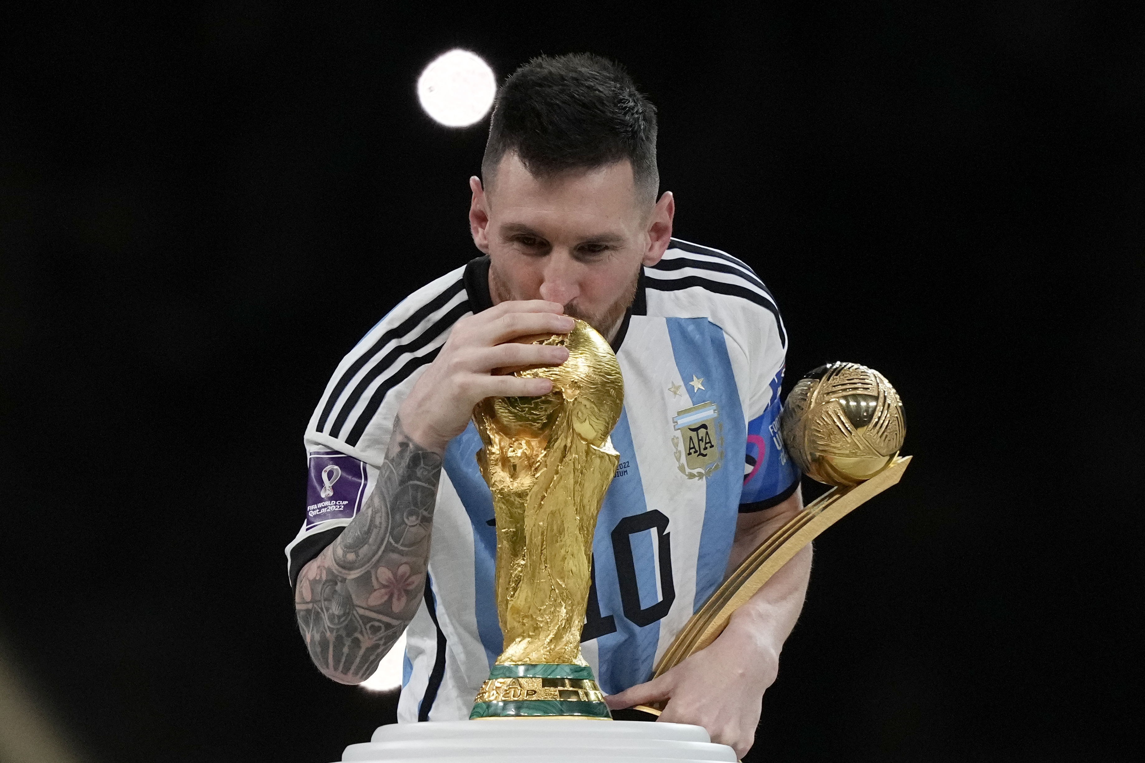 Argentina's Lionel Messi kisses the trophy after winning the World Cup final soccer match between Argentina and France at the Lusail Stadium in Lusail, Qatar, Sunday, Dec. 18, 2022. Argentina won 4-2 in a penalty shootout after the match ended tied 3-3. 