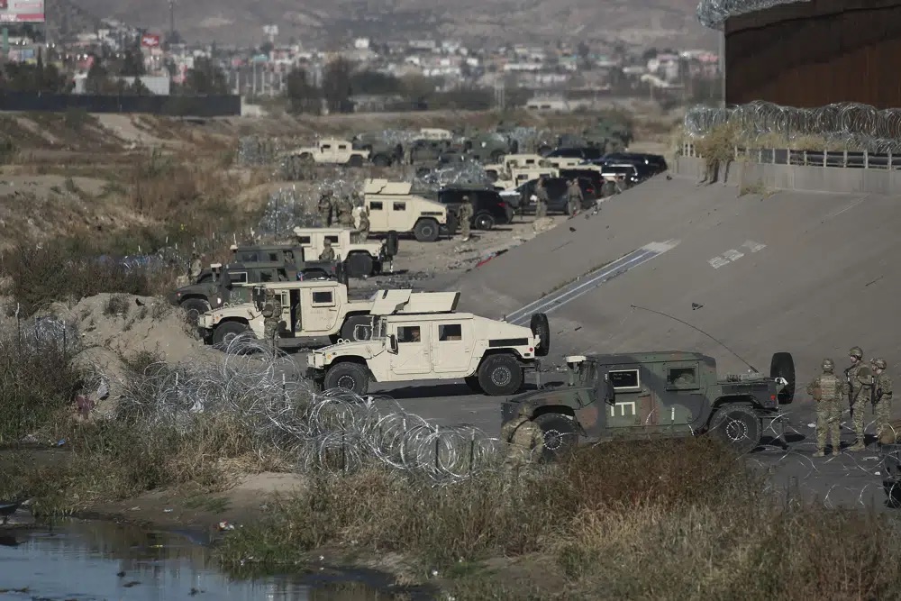 U.S. military guard El Paso's border with Mexico, seen from Ciudad Juarez, Mexico, Tuesday. The Supreme Court issued a temporary order to keep pandemic-era limits on asylum-seekers in place, though it could be brief, as conservative-leaning states push to maintain a measure that allows officials to expel many but not all asylum-seekers.