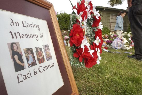 Photographs of Laci Peterson are placed at a memorial outside the home of Scott and Laci Peterson April 20, 2003 in Modesto, California. A California judge on Tuesday rejected a new murder trial for Peterson, nearly 20 years after he was charged with dumping the bodies of his pregnant wife and the unborn child they planned to name Conner into the San Francisco Bay on Christmas Eve 2002.