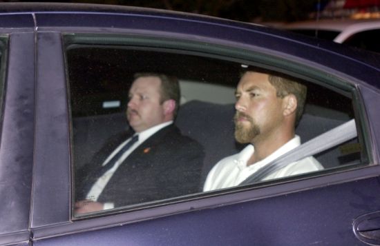 Scott Peterson, right, arrives at a county jail in Modesto, California, coming from San Diego on April 19, 2003, after he was arrested in connection with the death of his wife, Laci Peterson, who was eight months pregnant when she vanished on Christmas Eve. A California judge on Tuesday rejected a new murder trial for Peterson, nearly 20 years after he was charged with dumping the bodies of his pregnant wife and the unborn child they planned to name Conner into the San Francisco Bay on Christmas Eve 2002.