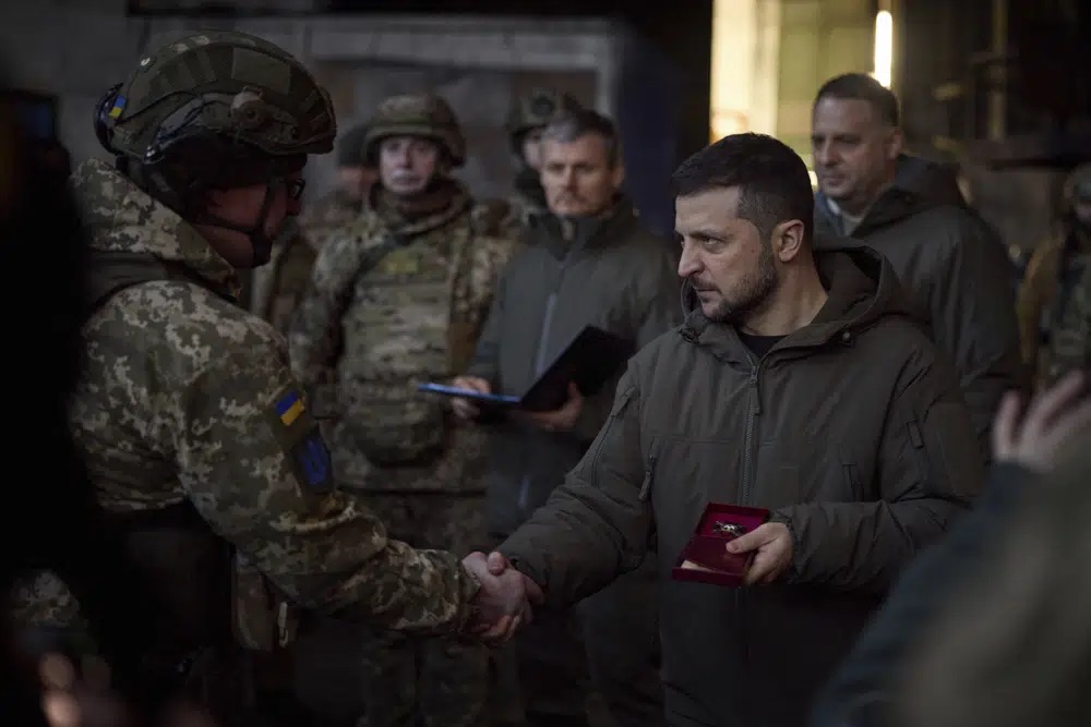 Ukrainian President Volodymyr Zelenskyy, right, awards a serviceman at the site of the heaviest battles with the Russian invaders in Bakhmut, Ukraine, Tuesday.