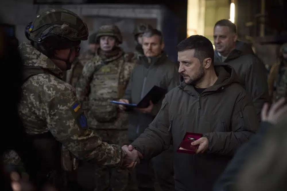 Ukrainian President Volodymyr Zelenskyy, right, awards a serviceman at the site of the heaviest battles with the Russian invaders in Bakhmut, Ukraine, Tuesday.