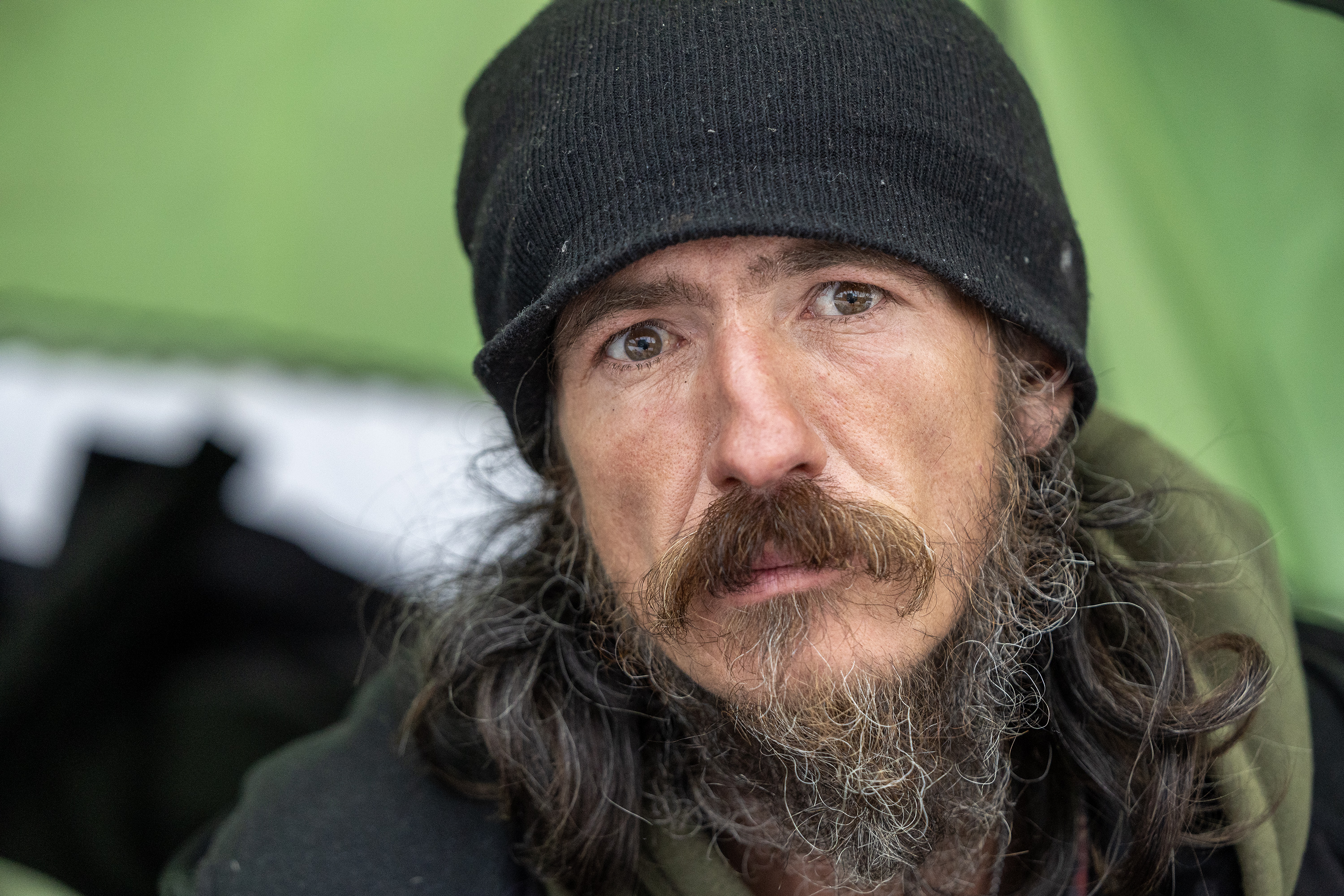 Robert Arguelles poses for a photo as he sits in the door of his tent in Salt Lake City. Five unsheltered people have died on Salt Lake streets over the past couple of days amid freezing temperatures, prompting an emergency declaration by Salt Lake City's mayor.