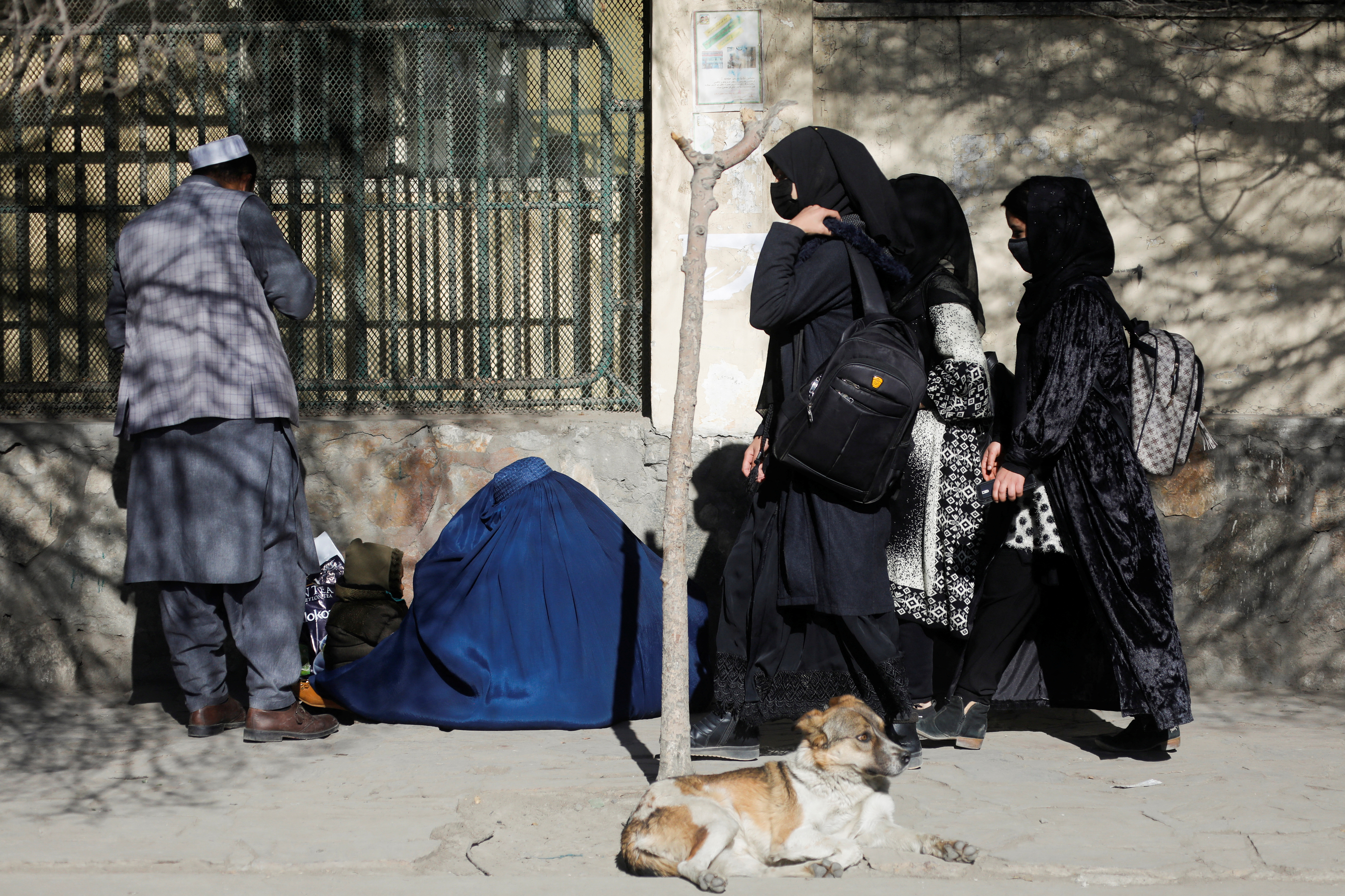 Afghan female students walk near Kabul University in Kabul, Afghanistan, Wednesday. Female university students in Afghanistan were turned away from campuses on Wednesday after the Taliban-run administration said women would be suspended from tertiary education.