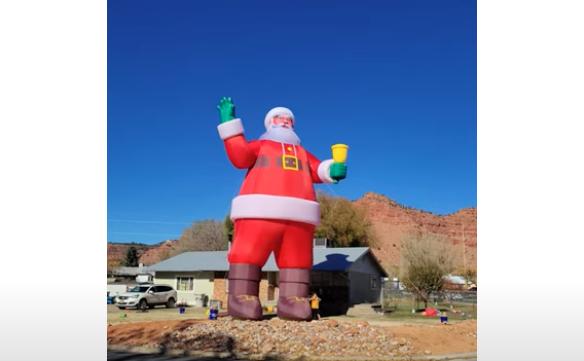 A 40-foot Santa inflatable towers over Zed Broadhead's home in Kanab.