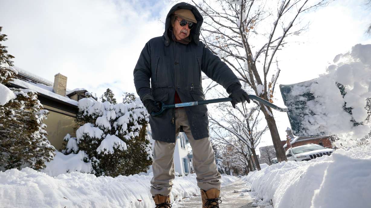 John Russell shovels the sidewalk in front of his house after a snowstorm in Salt Lake City on Dec. 15. Winter solstice is Wednesday afternoon in Utah.
