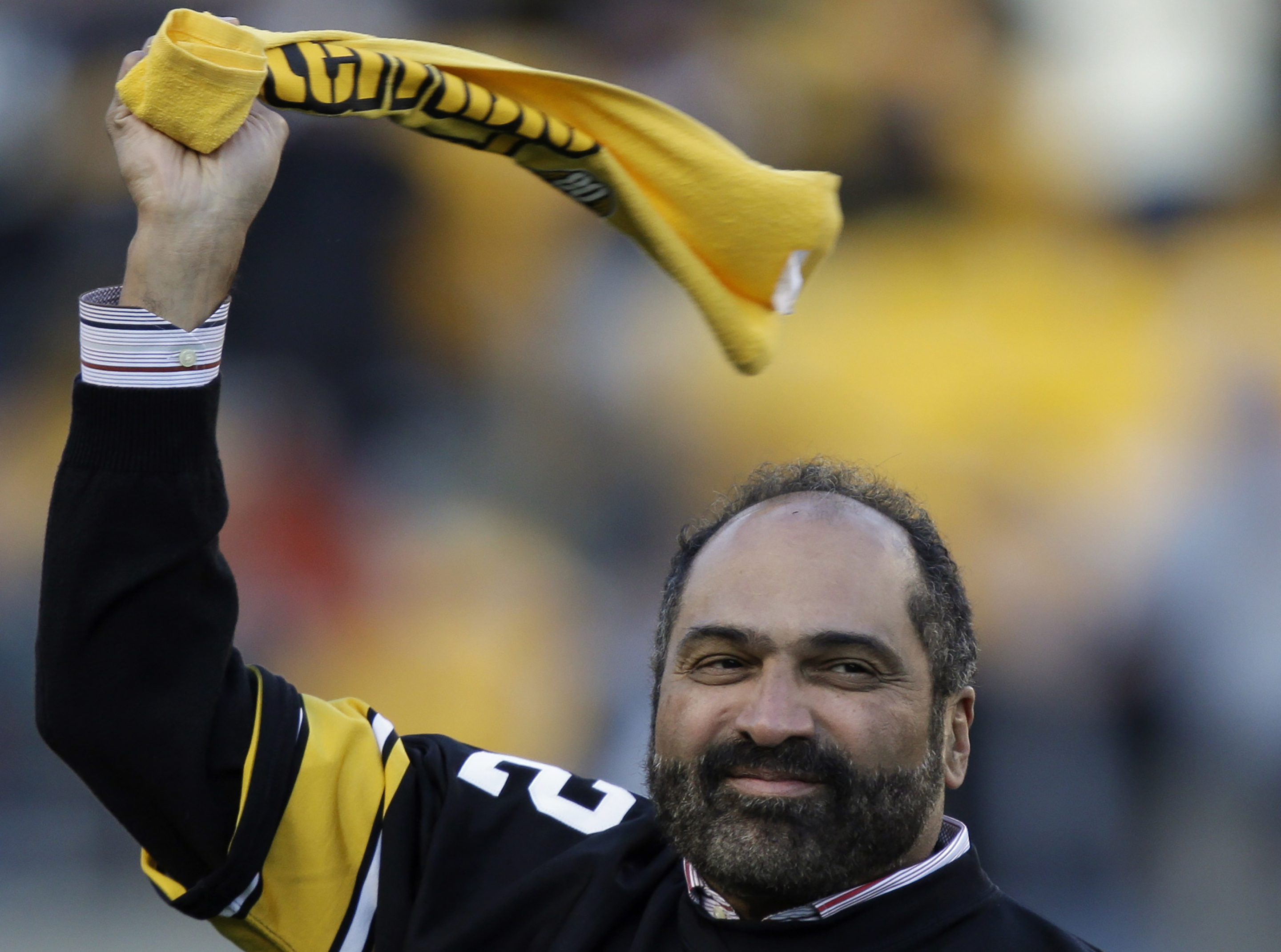 FILE - Pittsburgh Steelers Hall of Fame running back Franco Harris twirls a Terrible Towel during a ceremony commemorating the 40th anniversary of his "Immaculate Reception" catch in the 1972 playoff game against the Oakland Raiders, during the halftime of an NFL football game between the Steelers and the Cincinnati Bengals in Pittsburgh, Sunday, Dec. 23, 2012. Franco Harris, the Hall of Fame running back whose heads-up thinking authored “The Immaculate Reception,” considered the most iconic play in NFL history, died Wednesday, Dec. 21, 2022. He was 72. 