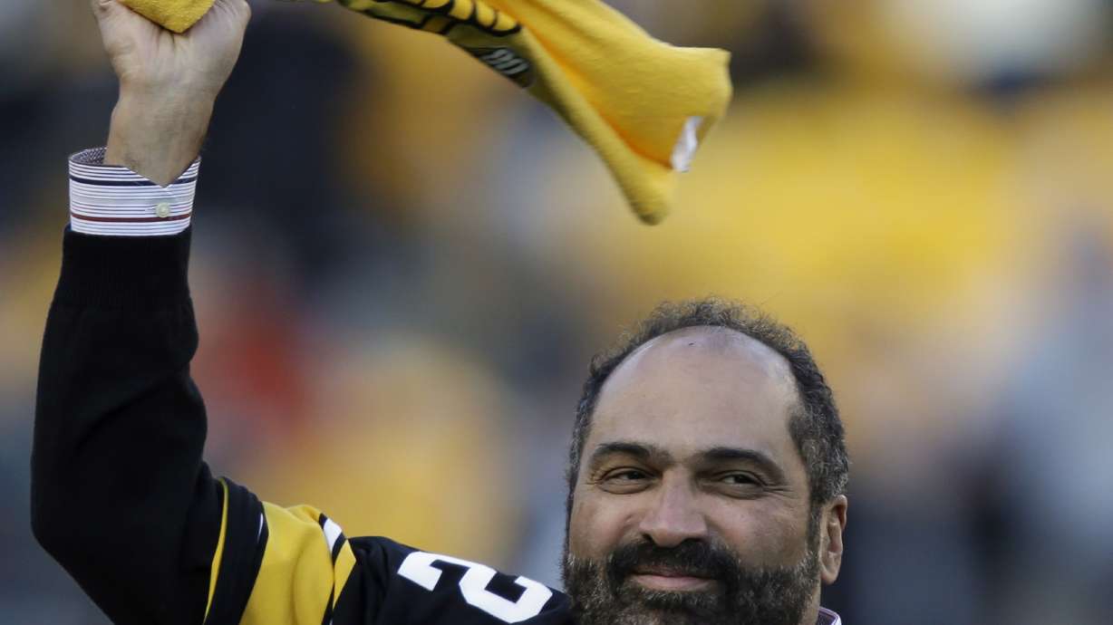 FILE - Pittsburgh Steelers Hall of Fame running back Franco Harris twirls a Terrible Towel during a ceremony commemorating the 40th anniversary of his "Immaculate Reception" catch in the 1972 playoff game against the Oakland Raiders, during the halftime of an NFL football game between the Steelers and the Cincinnati Bengals in Pittsburgh, Sunday, Dec. 23, 2012. Franco Harris, the Hall of Fame running back whose heads-up thinking authored “The Immaculate Reception,” considered the most iconic play in NFL history, died Wednesday, Dec. 21, 2022. He was 72.