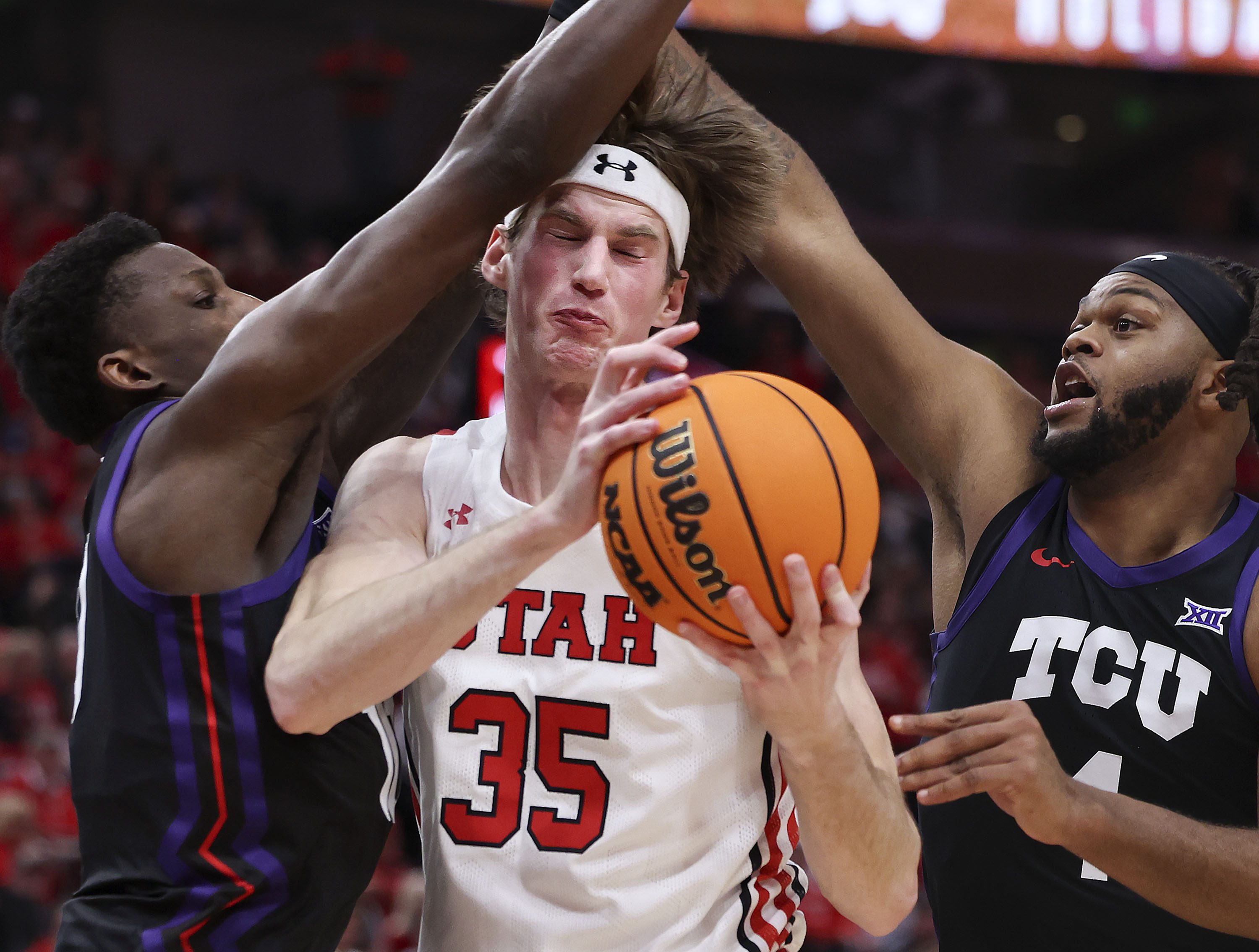 TCU Horned Frogs guard Damion Baugh (10) and center Eddie Lampkin Jr. (4) double team Utah Utes center Branden Carlson (35) at Vivint Arena in Salt Lake City on Wednesday, Dec. 21, 2022.