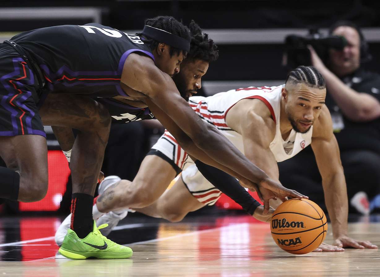 Utah Utes guard Marco Anthony (10) and TCU Horned Frogs guard Mike Miles Jr. (1) and forward Emanuel Miller (2) compete for a loose ball at Vivint Arena in Salt Lake City on Wednesday, Dec. 21, 2022.