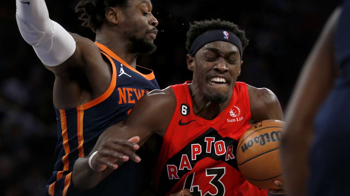 Toronto Raptors forward Pascal Siakam (43) drives past New York Knicks forward Julius Randle, left, during the first half of an NBA basketball game Wednesday, Dec. 21, 2022, in New York.