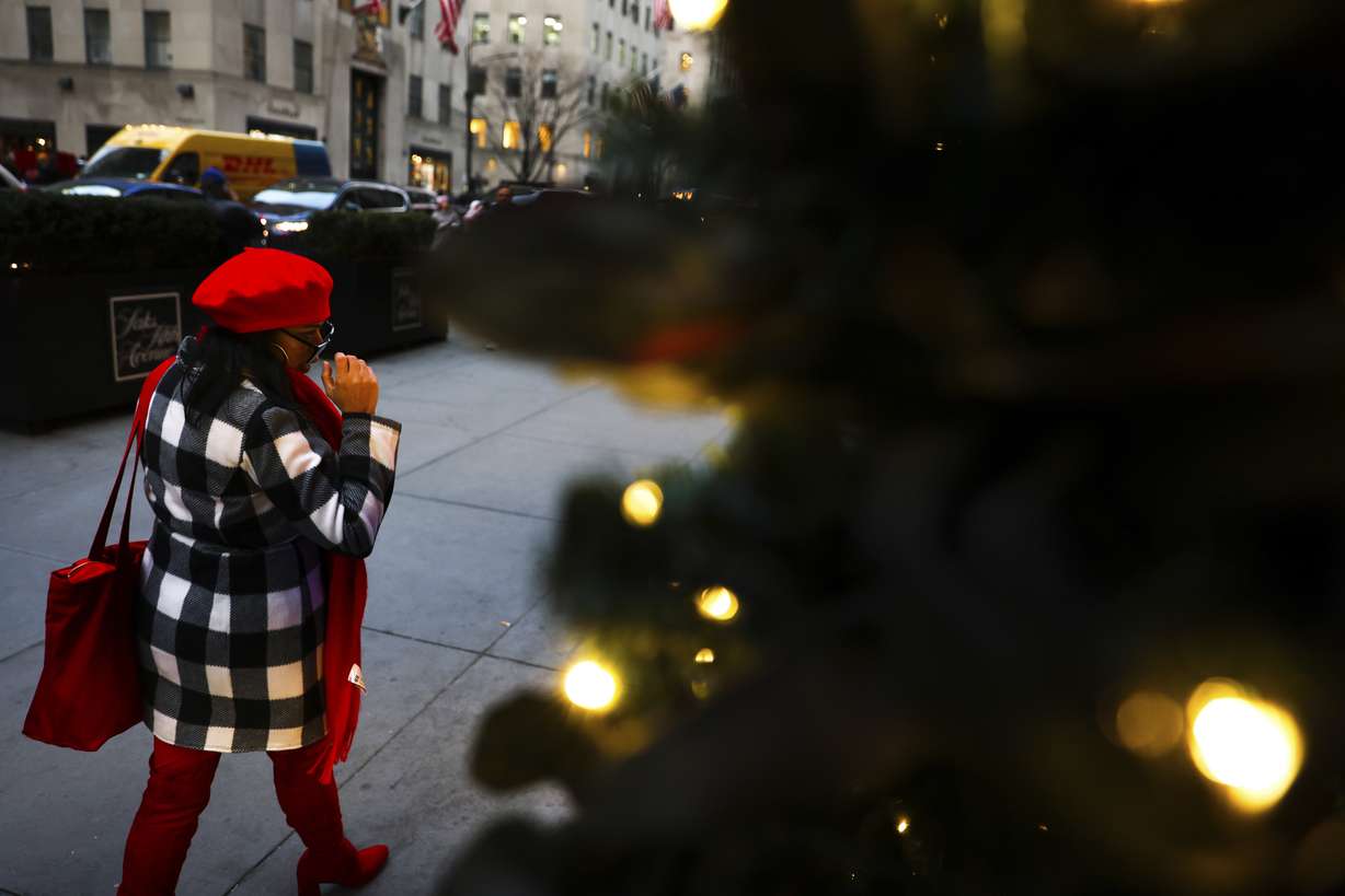 A person looks at window displays on Saks Fifth Avenue on Monday in New York.