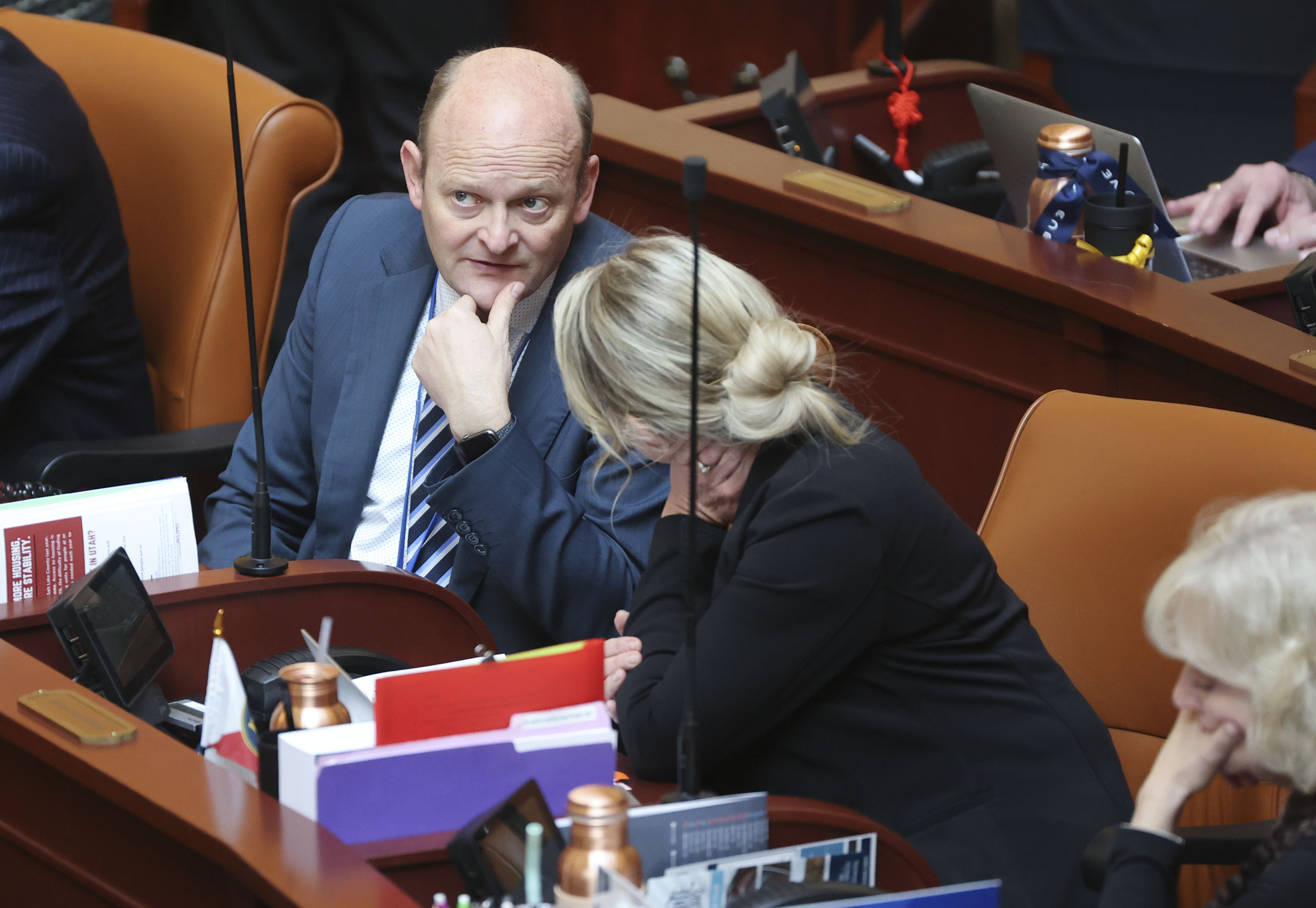 Rep. Adam Robertson, R-Provo, talks to Rep. Melissa Garff Ballard, R-North Salt Lake, in the House chamber at the Capitol in Salt Lake City on Feb. 11. The Utah County Republican Party announced Wednesday that it has received Robertson's resignation.