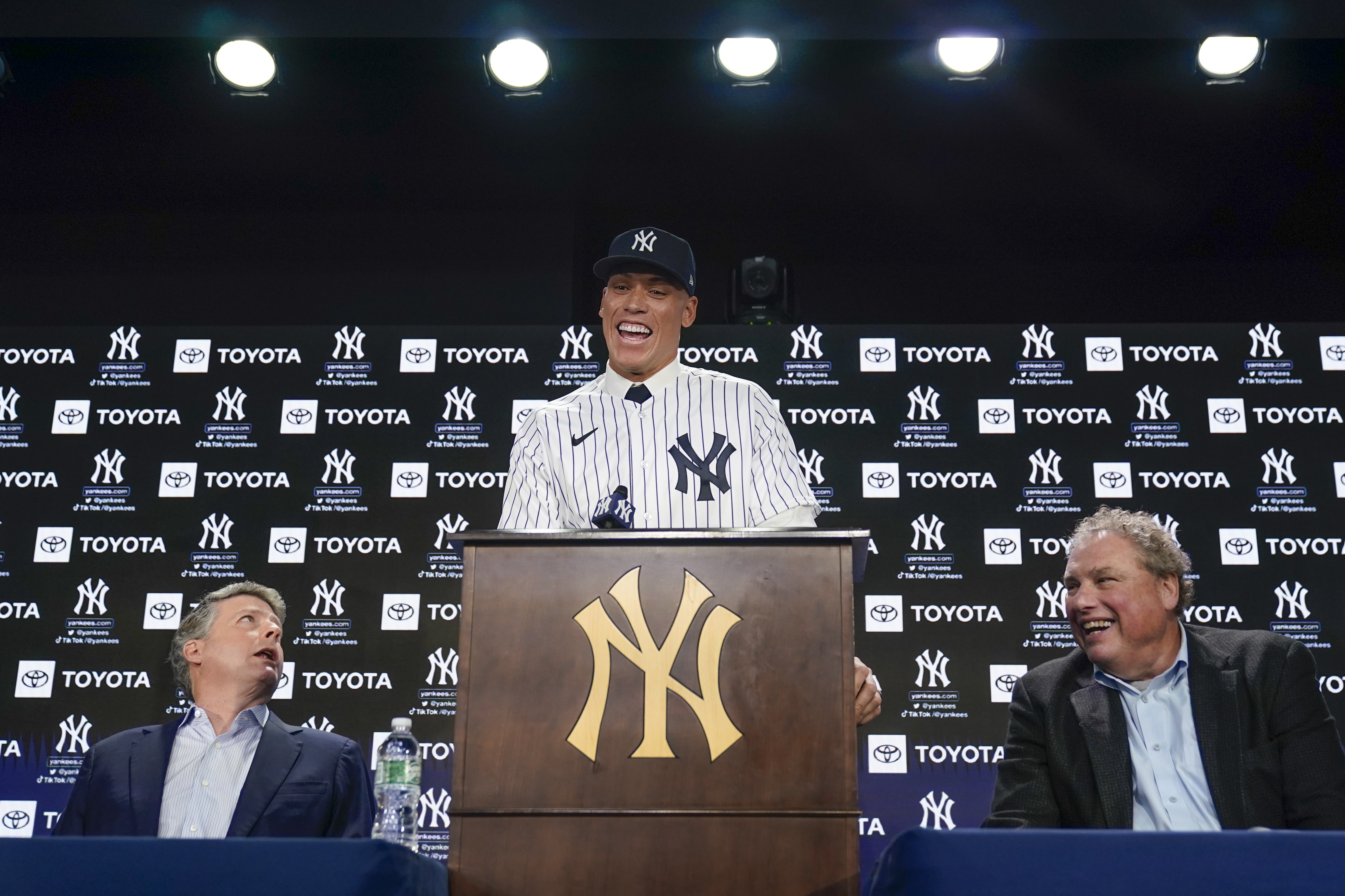 New York Yankees' Aaron Judge, center, speaks while owner Hal Steinbrenner, left, and president Randy Levine look on during a baseball news conference at Yankee Stadium, Wednesday, Dec. 21, 2022, in New York. Judge has been appointed captain of the New York Yankees after agreeing to a $360 million, nine-year contract to remain in pinstripes. 