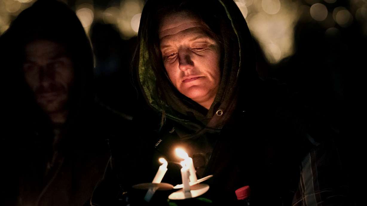 JoAnne Johanson, whose children both died while experiencing homelessness, attends the annual candlelight vigil honoring those who died while homeless this year at Pioneer Park in Salt Lake City on Wednesday. At least 159 people who were homeless in Utah died in 2022.
