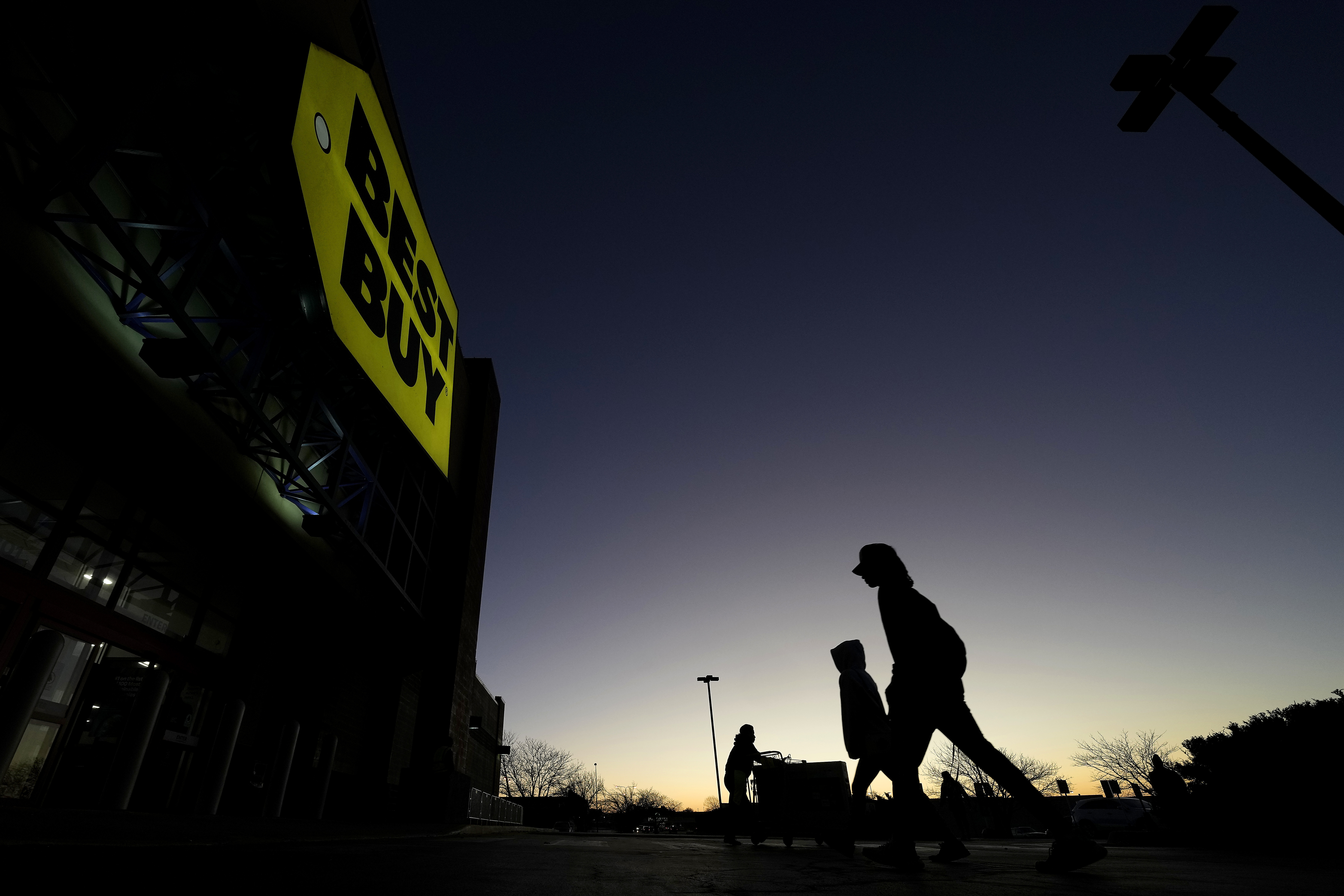 Shoppers arrive at a Best Buy store Nov. 25, in Overland Park, Kan. A measure of inflation closely watched by the Federal Reserve slowed last month, the government reported Friday.