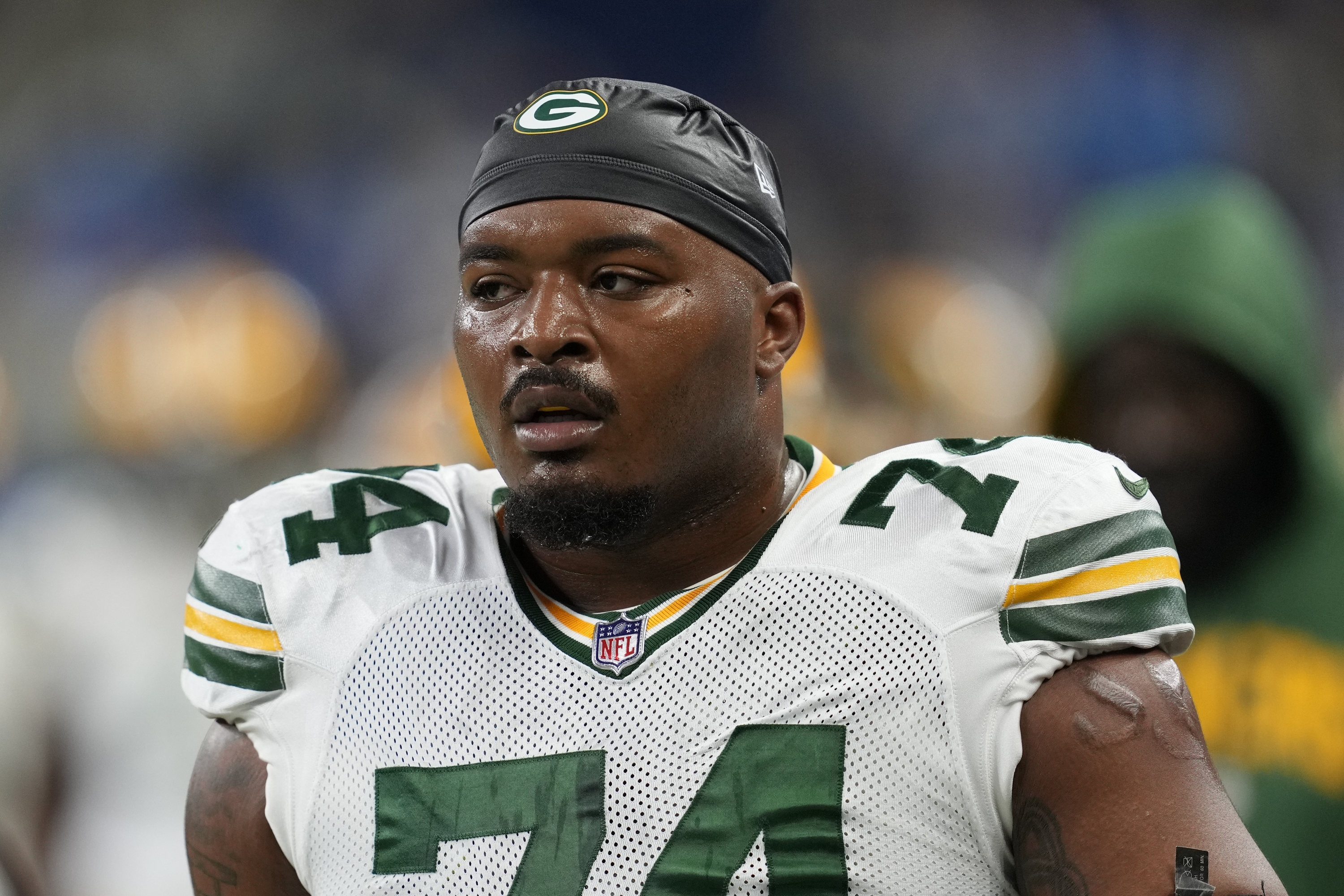 FILE - Green Bay Packers guard Elgton Jenkins (74) watches during an NFL football game against the Detroit Lions in Detroit, Sunday, Nov. 6, 2022. A person familiar with the situation says Green Bay Packers offensive lineman Elgton Jenkins has agreed to a four-year contract extension worth at least $68 million.