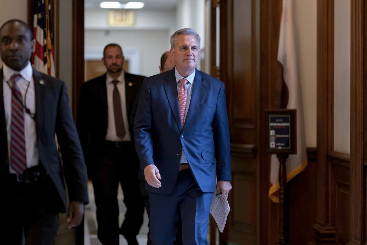 House Minority Leader Kevin McCarthy, R-Calif., walks to the chamber as lawmakers debate a massive $1.7 trillion spending bill that finances federal agencies and provides aid to Ukraine, at the Capitol in Washington, Friday.