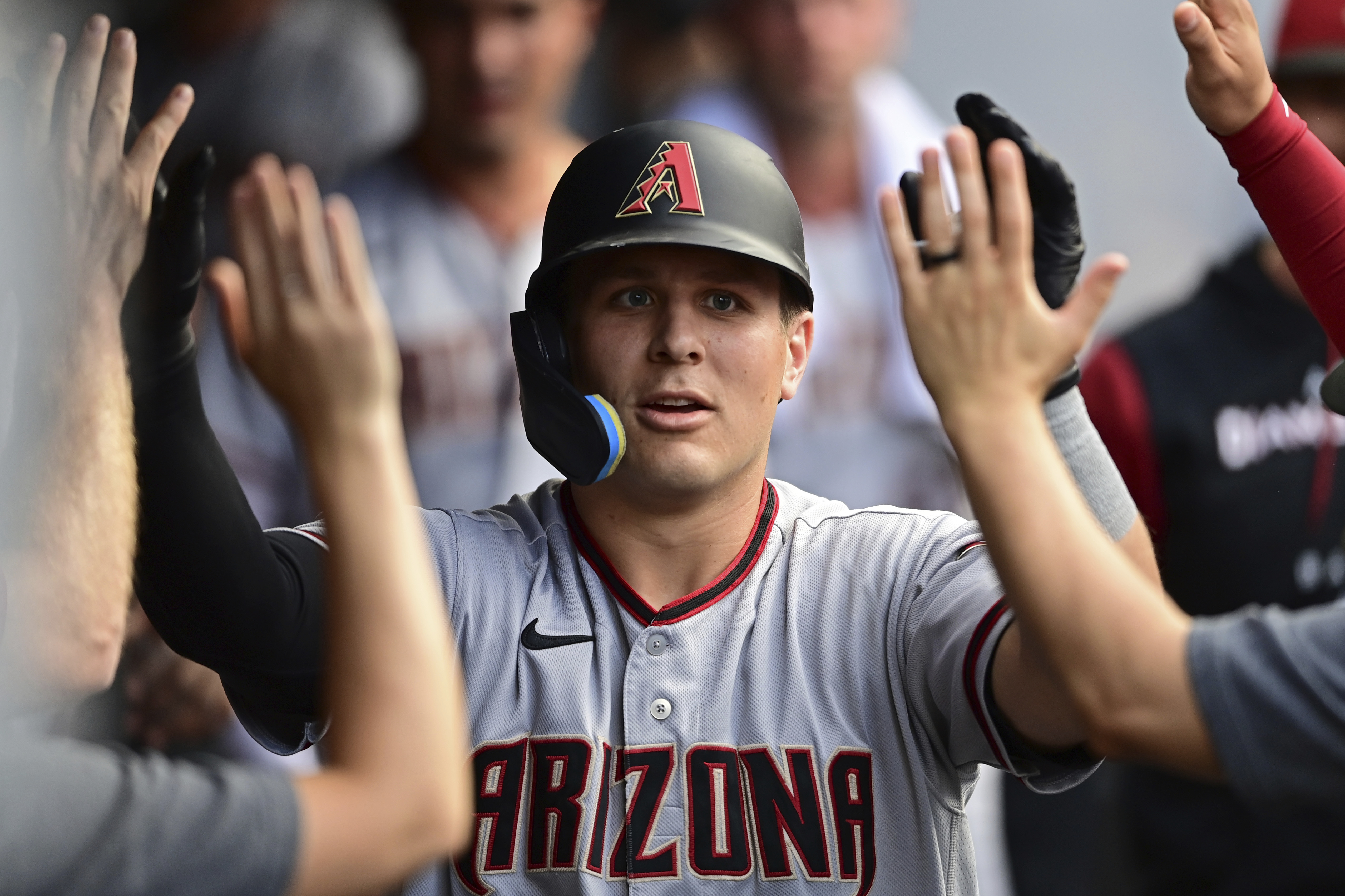 FILE -Arizona Diamondbacks' Daulton Varsho is congratulated int he dugout after hitting a solo home run off Cleveland Guardians starting pitcher Cal Quantrill during the fourth inning of a baseball game, Monday, Aug. 1, 2022, in Cleveland. The Arizona Diamondbacks acquired highly regarded catching prospect Gabriel Moreno and veteran outfielder Lourdes Gurriel Jr. on Friday, Dec. 23, 2022, sending slugger Daulton Varsho to the Toronto Blue Jays.