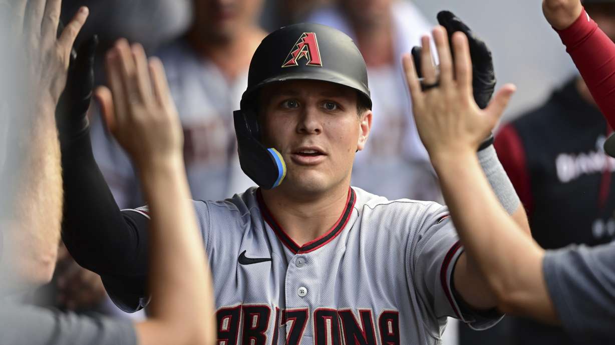 FILE -Arizona Diamondbacks' Daulton Varsho is congratulated int he dugout after hitting a solo home run off Cleveland Guardians starting pitcher Cal Quantrill during the fourth inning of a baseball game, Monday, Aug. 1, 2022, in Cleveland. The Arizona Diamondbacks acquired highly regarded catching prospect Gabriel Moreno and veteran outfielder Lourdes Gurriel Jr. on Friday, Dec. 23, 2022, sending slugger Daulton Varsho to the Toronto Blue Jays.