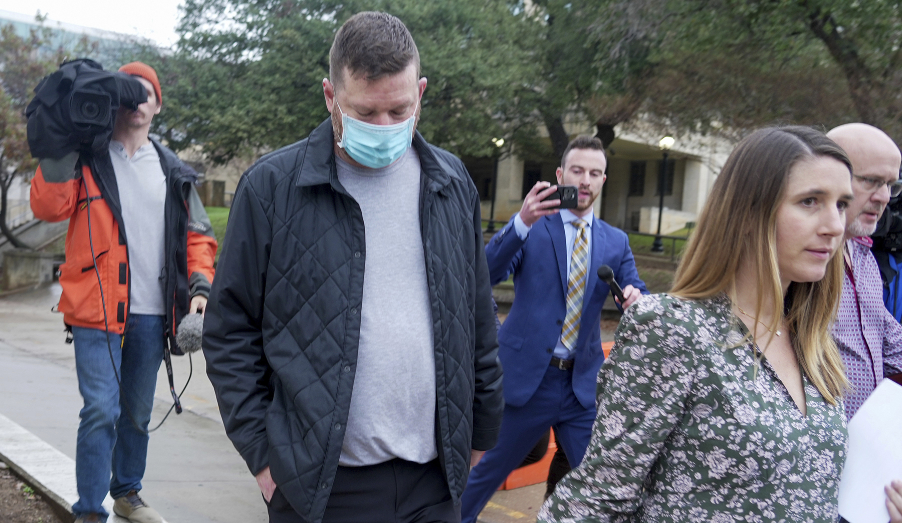 Texas men's basketball coach Chris Beard, second left, walks out of the Travis County Jail with his Defense Attorney Perry Q. Minton, right, in Austin, Texas, Monday, Dec. 12, 2022. Beard was arrested on a felony family violence charge.