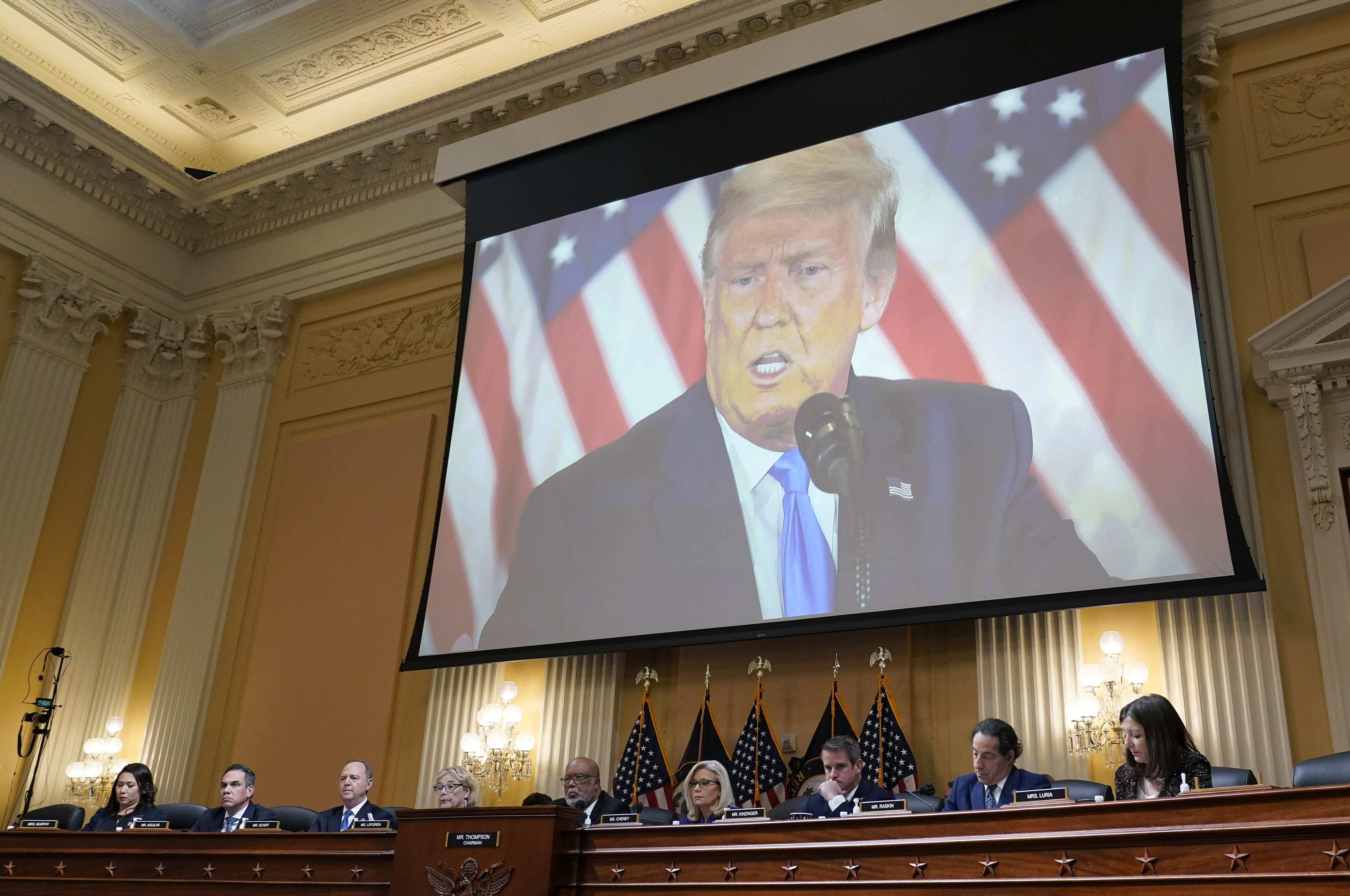 A video of former President Donald Trump is shown on a screen, as the House select committee investigating the Jan. 6 attack on the U.S. Capitol holds its final meeting on Capitol Hill in Washington, Dec. 19.