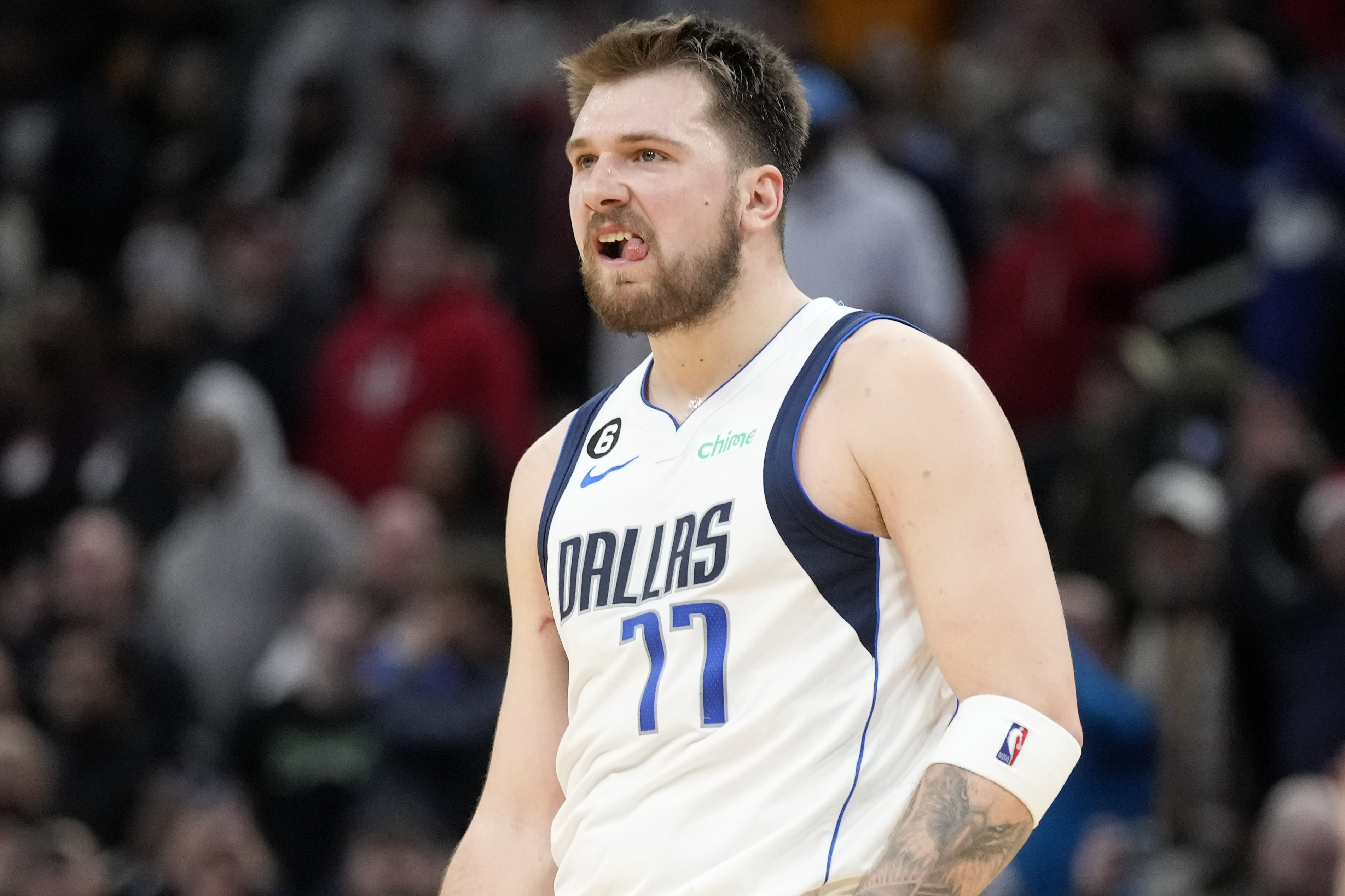 Dallas Mavericks guard Luka Doncic reacts after making a 3-point basket during the second half of an NBA basketball game against the Houston Rockets, Friday, Dec. 23, 2022, in Houston. 