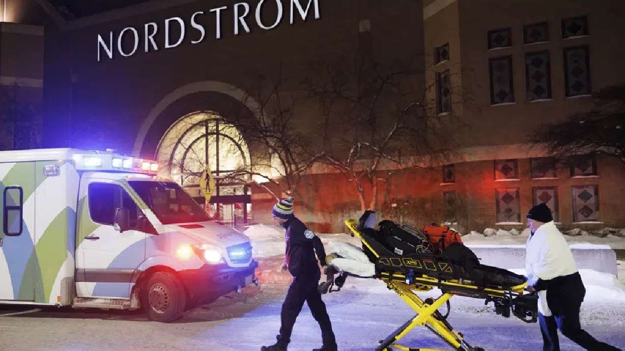 Two first responders and an ambulance are seen at the entrance to Nordstrom at the Mall of America in Bloomington, Minn., after reports of shots fired on Friday.