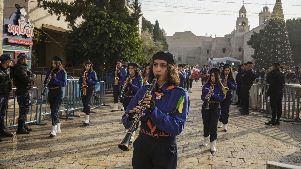 Girls scouts march during a Christmas parade in Manger Square, adjacent to the Church of the Nativity, traditionally believed to be the birthplace of Jesus Christ, in the West Bank town of Bethlehem on Saturday.