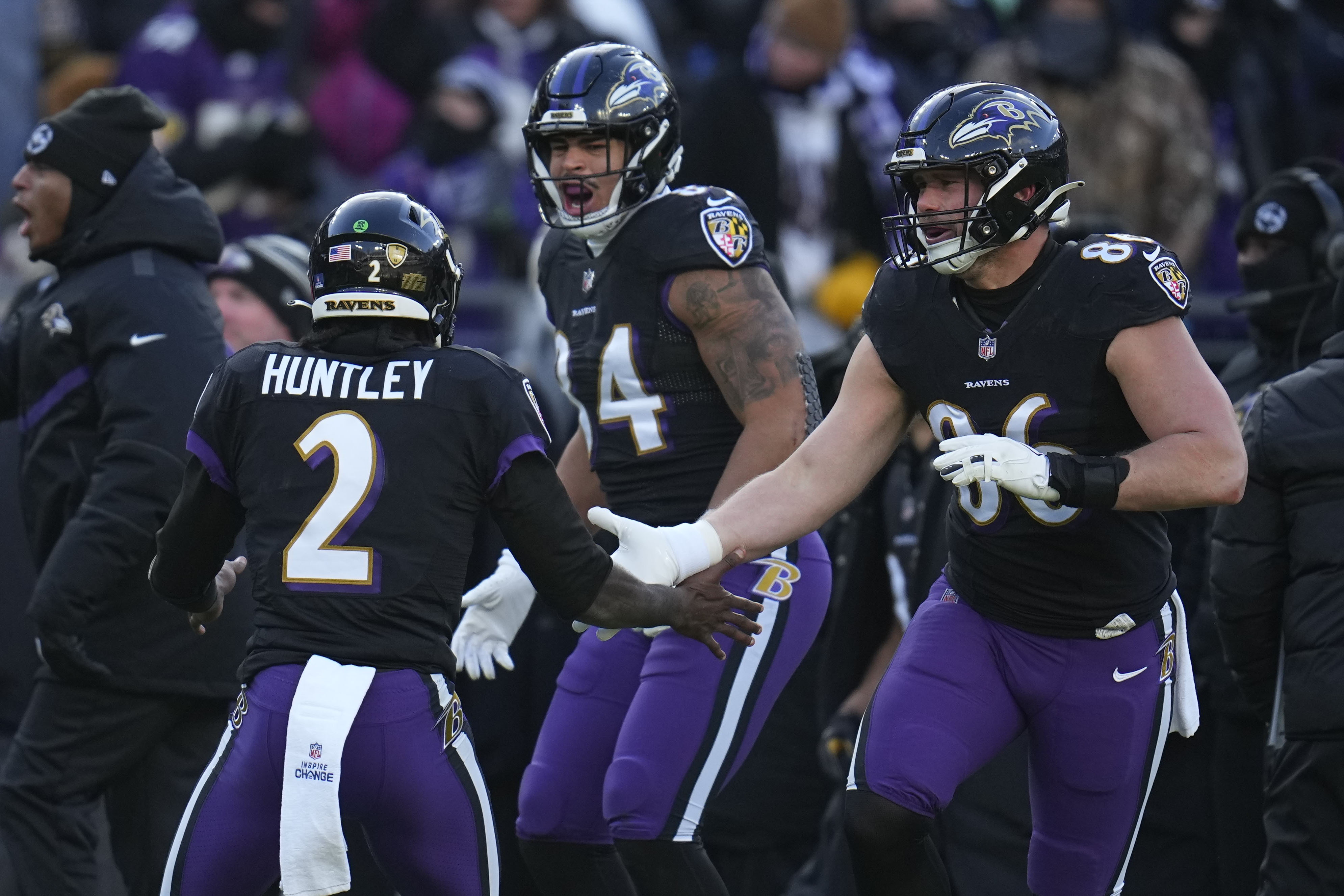 Baltimore Ravens quarterback Tyler Huntley (2) celebrates his touchdown pass with tight end Josh Oliver and tight end Nick Boyle (86) during the first half of an NFL football game, Saturday, Dec. 24, 2022, in Baltimore. 