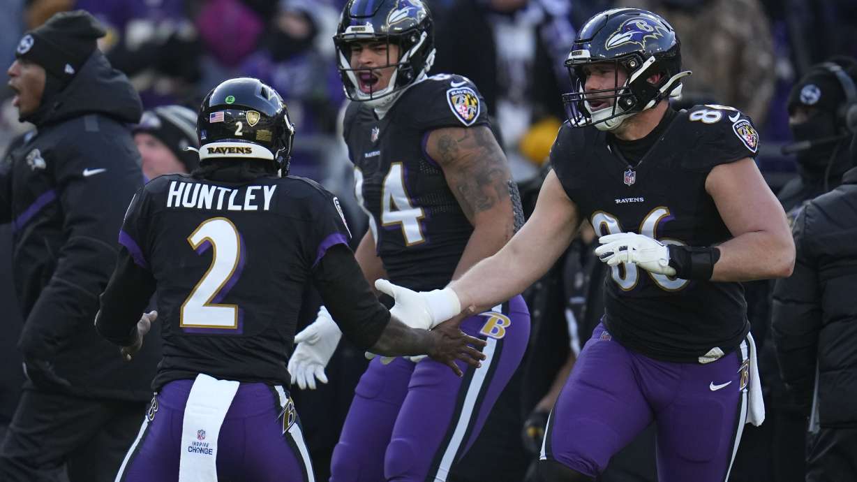 Baltimore Ravens quarterback Tyler Huntley (2) celebrates his touchdown pass with tight end Josh Oliver and tight end Nick Boyle (86) during the first half of an NFL football game, Saturday, Dec. 24, 2022, in Baltimore.