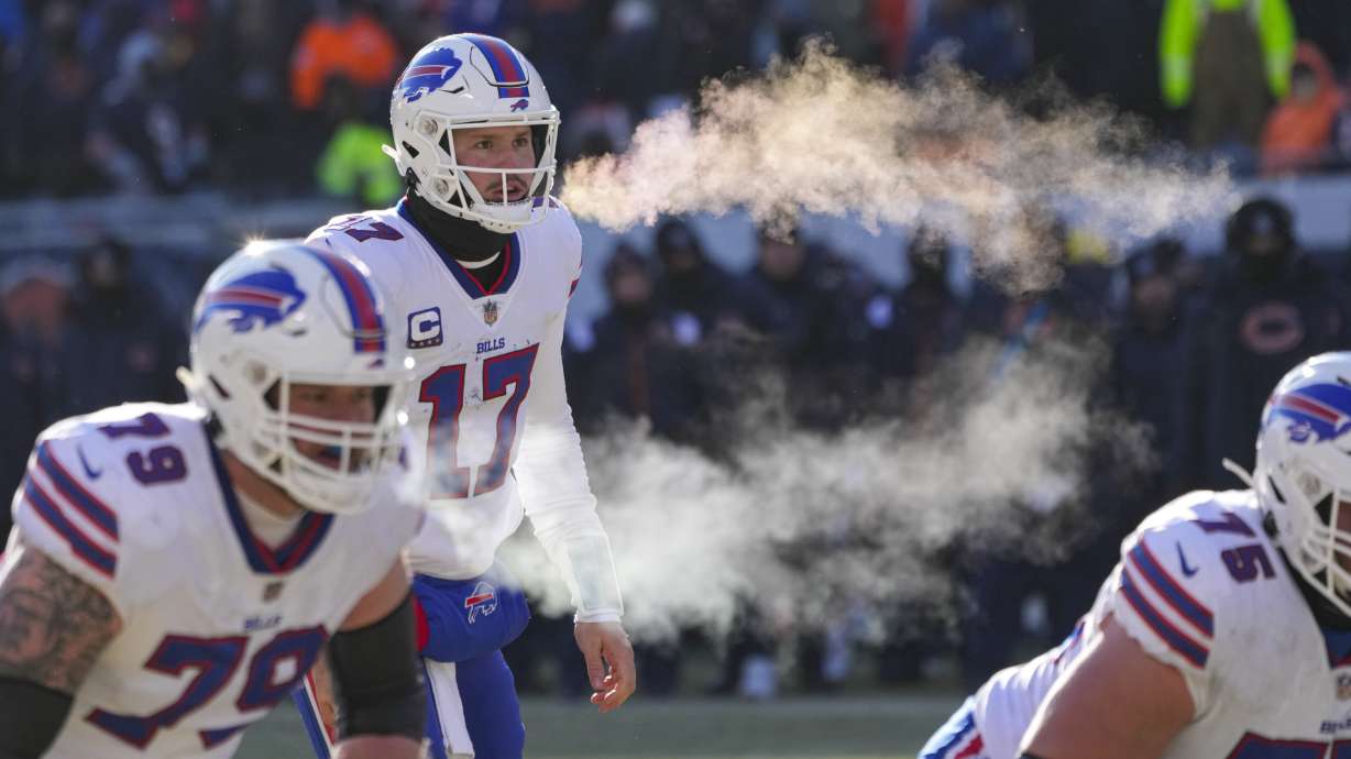 Buffalo Bills quarterback Josh Allen (17) and tackle Spencer Brown (79) exhale before a successful two-point attempt in the second half of an NFL football game against the Chicago Bears in Chicago, Saturday, Dec. 24, 2022.